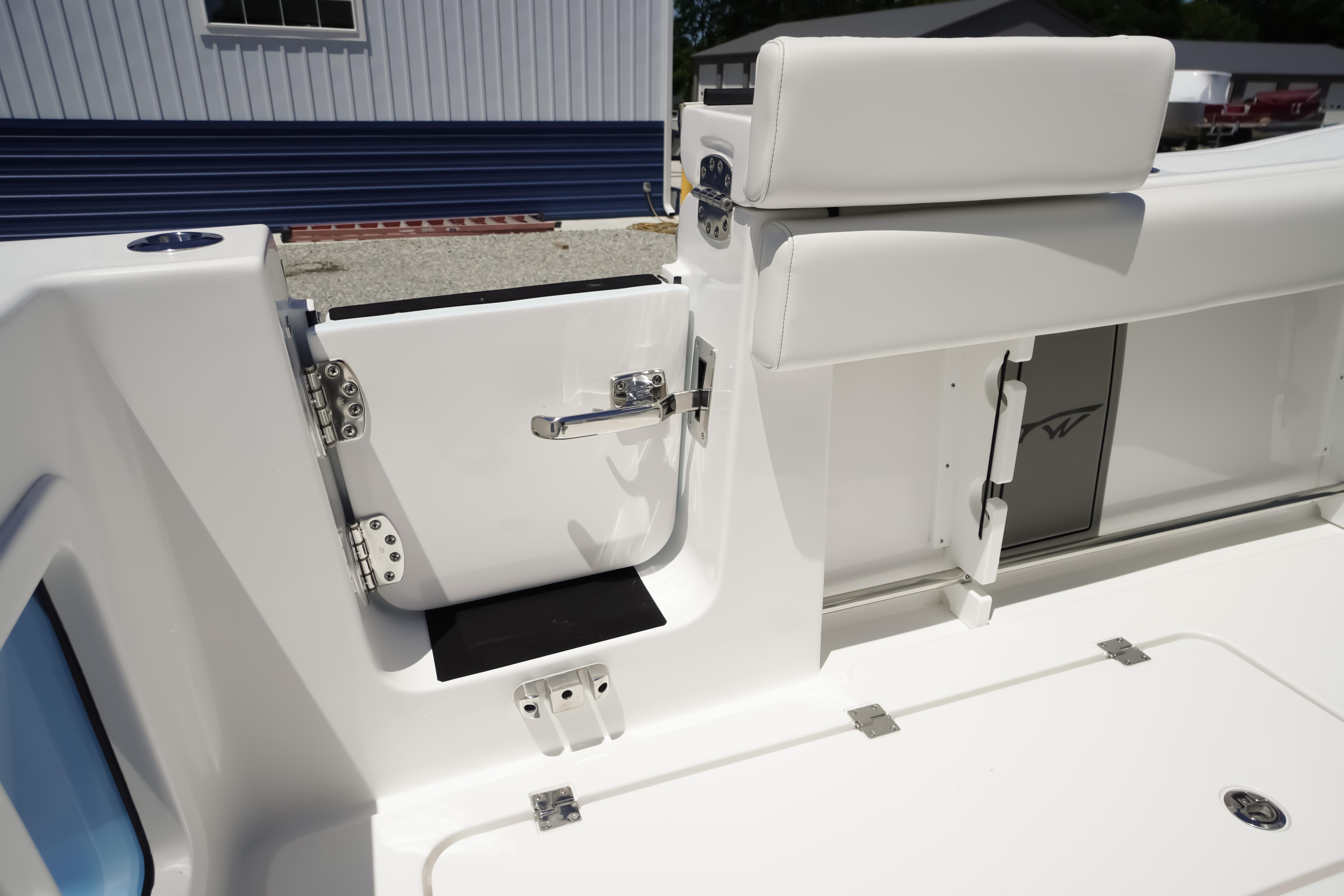 2026 Tidewater 302 CC Adventure boat interior, featuring sleek white seating and stainless steel hardware.