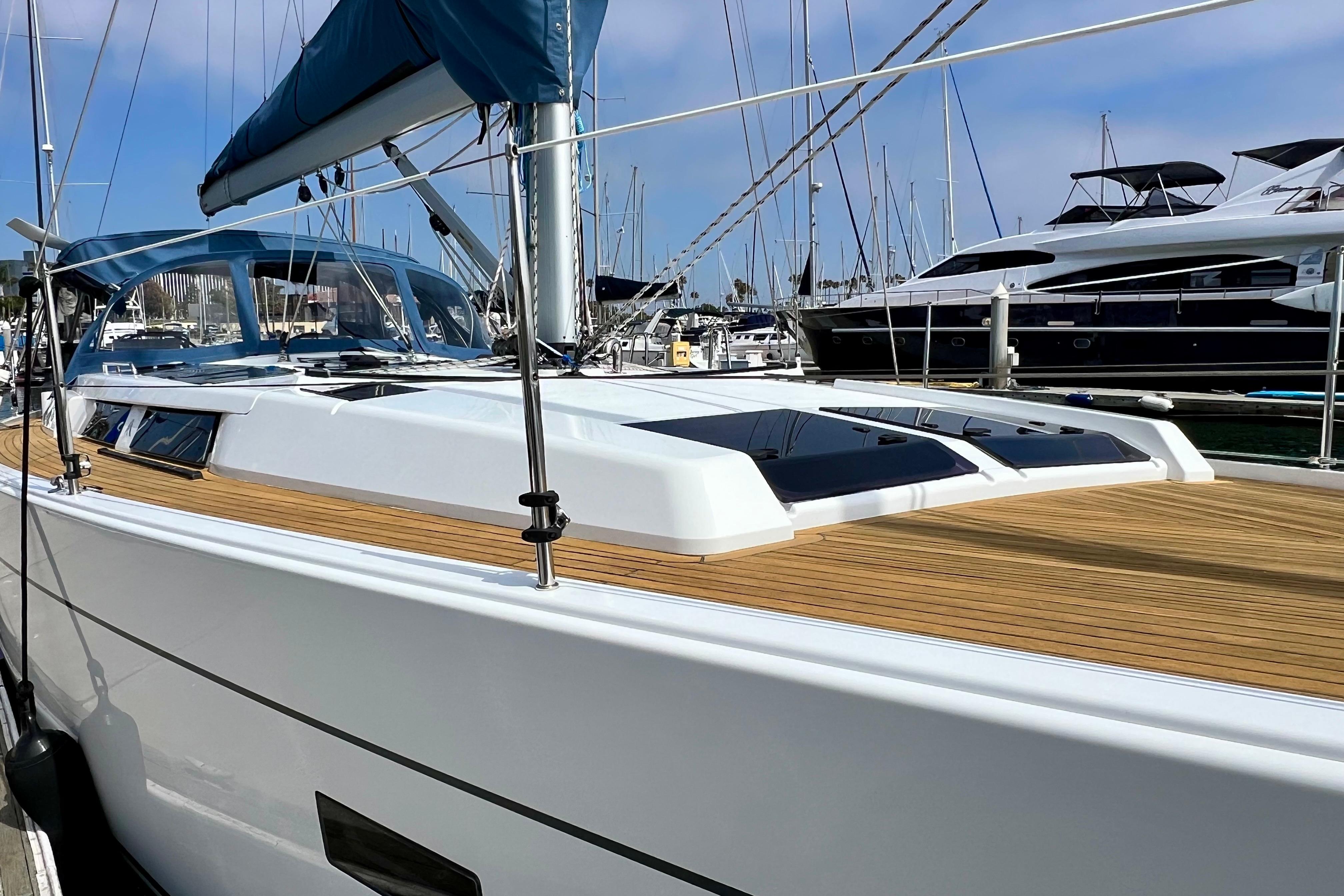 2016 Hanse 455 yacht with sleek design, docked in a marina, featuring a wooden deck.