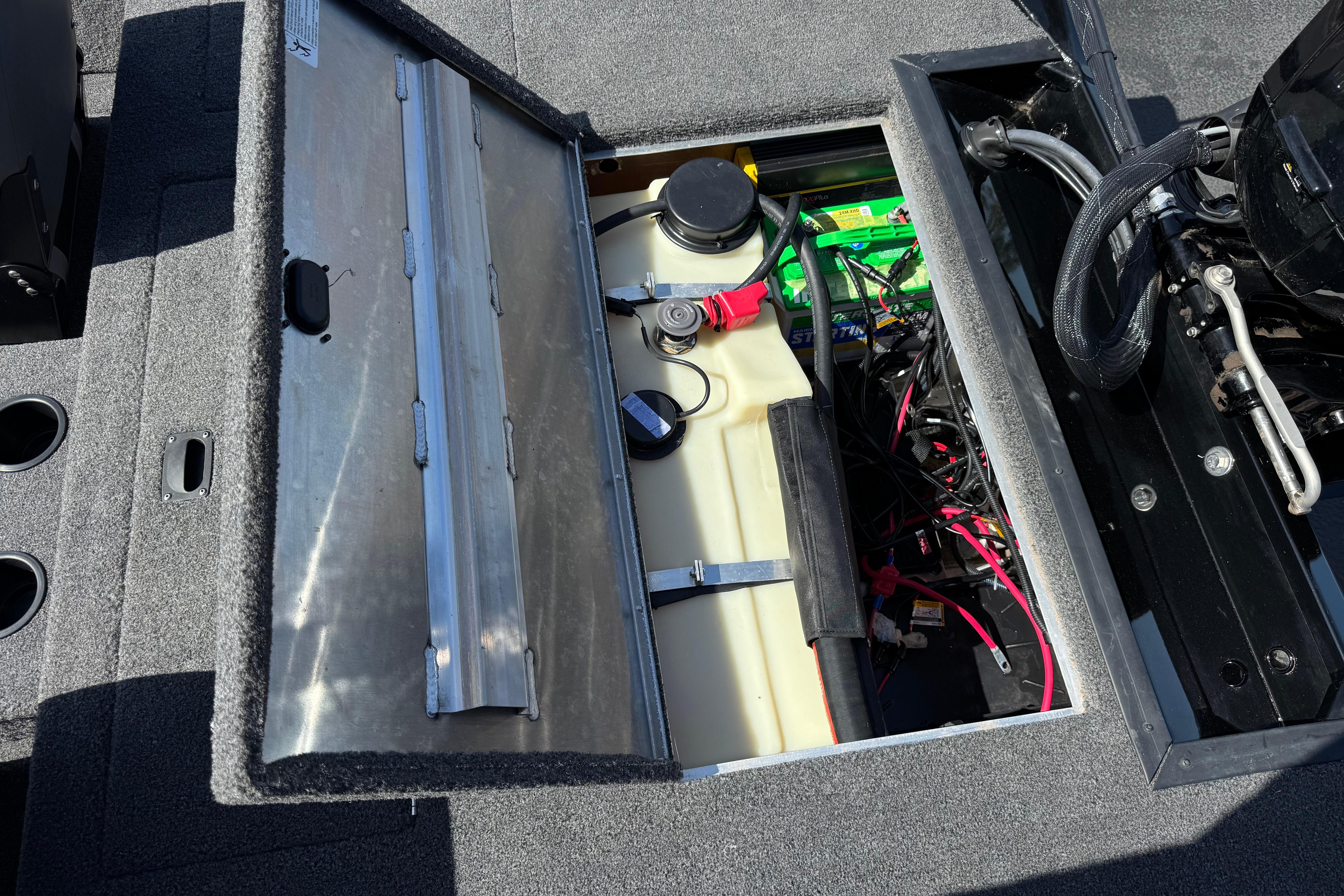 2024 Lowe Stinger 175 boat interior showing open storage compartment with battery and wiring.