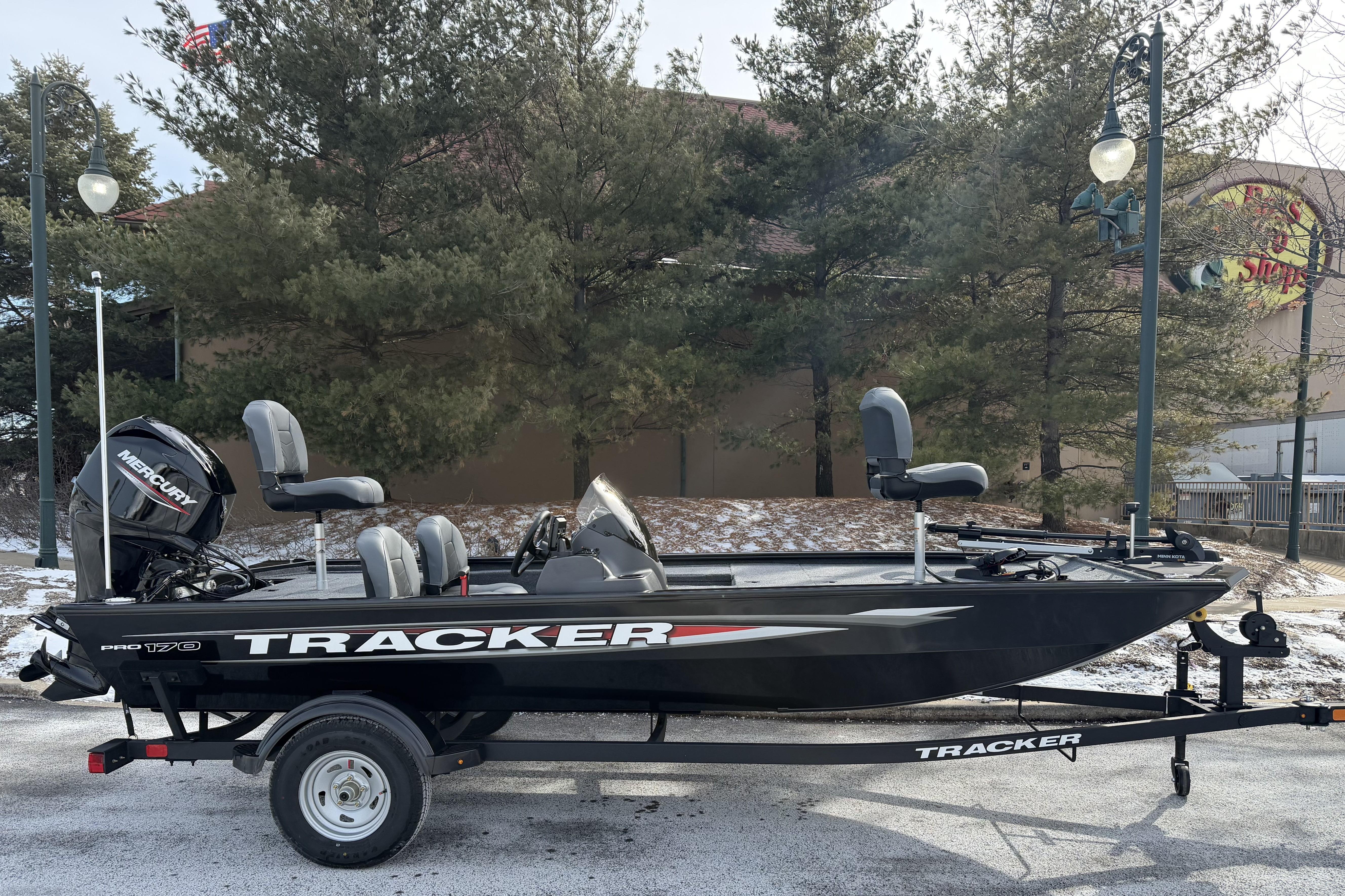 2026 Tracker Pro 170 fishing boat on trailer, parked outdoors with trees in background.