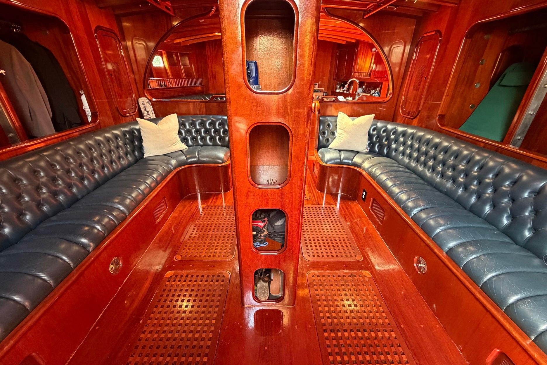 Luxurious 1992 Vic Carpenter Custom yacht interior with rich wood and leather seating.