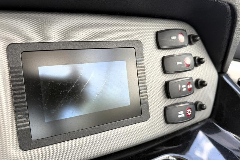 Dashboard of a 2017 Yamaha Boats SX210 with control switches and display screen.