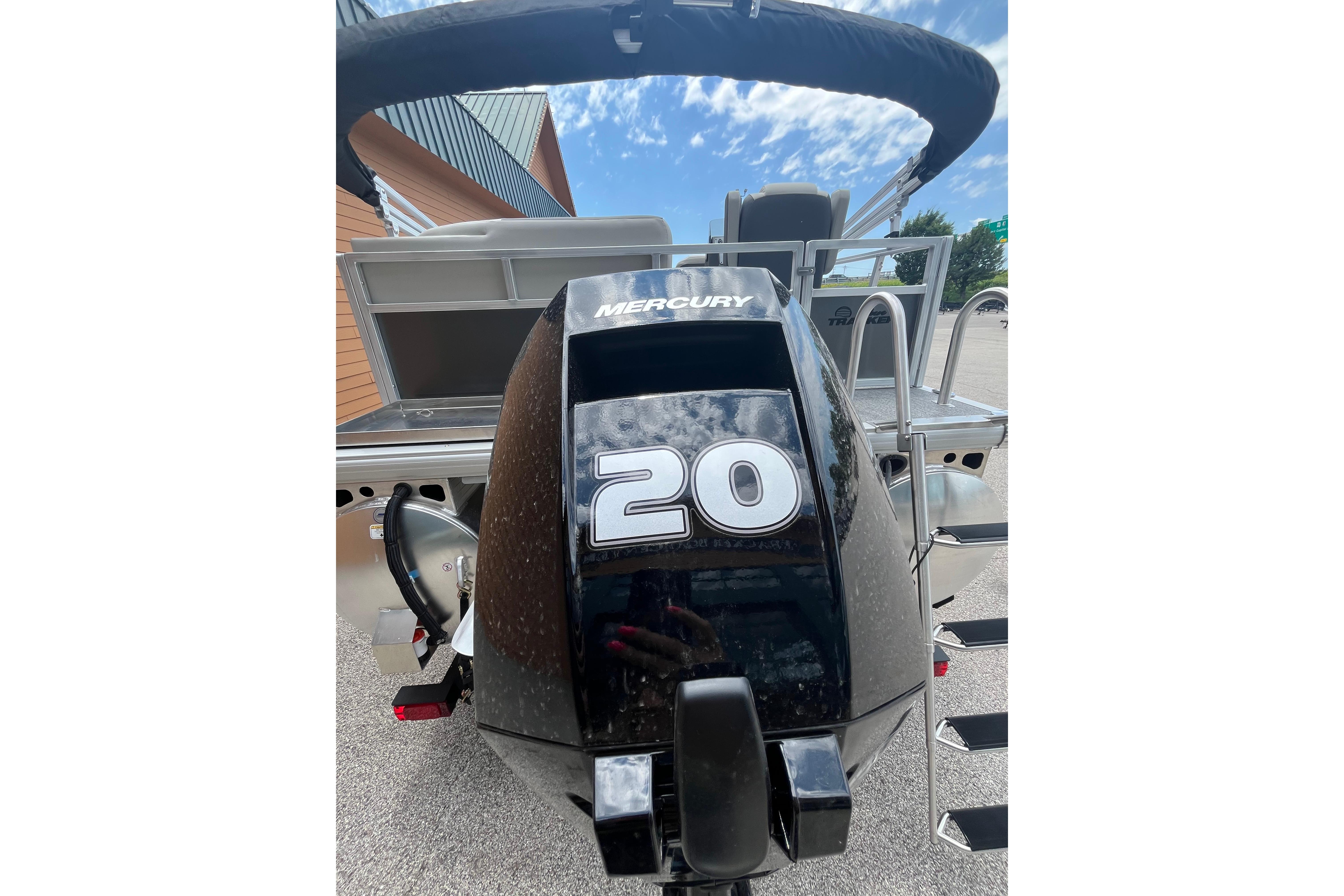 2026 Sun Tracker Bass Buggy 16 XL Select with Mercury 20 HP engine, outdoor view.