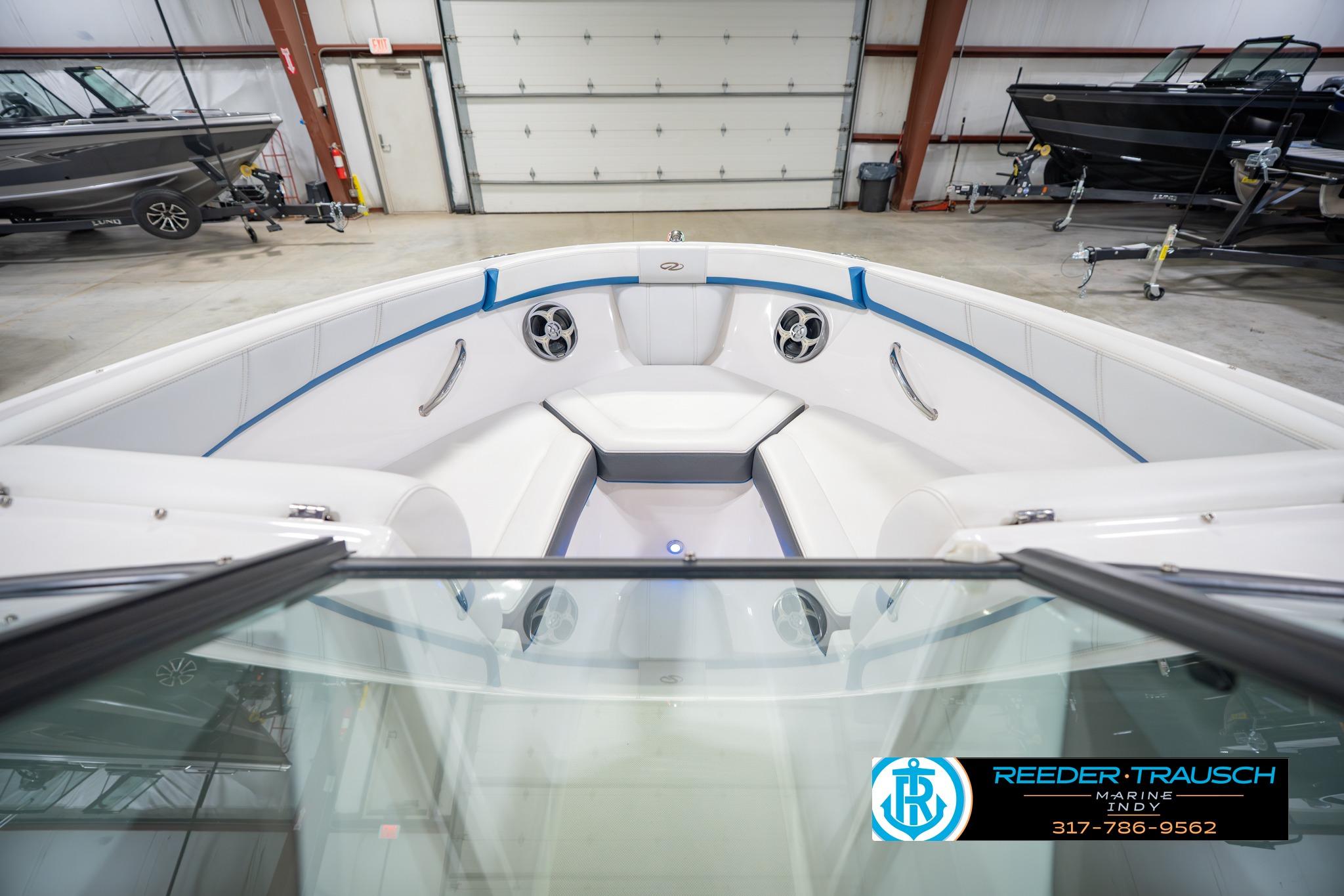 2015 Regal 2000 ESX Bowrider interior in showroom, featuring white seating and blue accents.