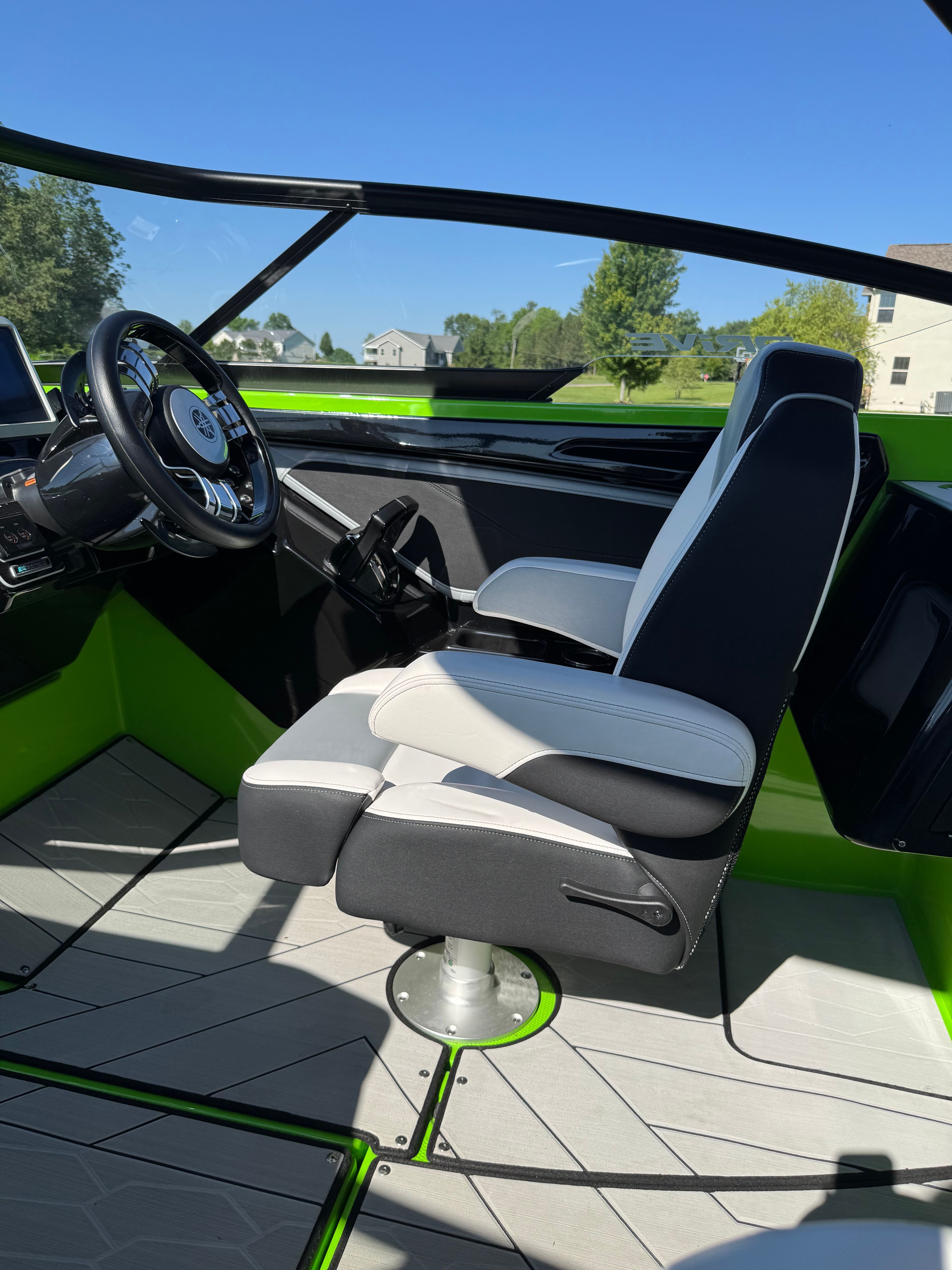 Interior of a 2022 Yamaha 255XD boat with modern seating and green accents.