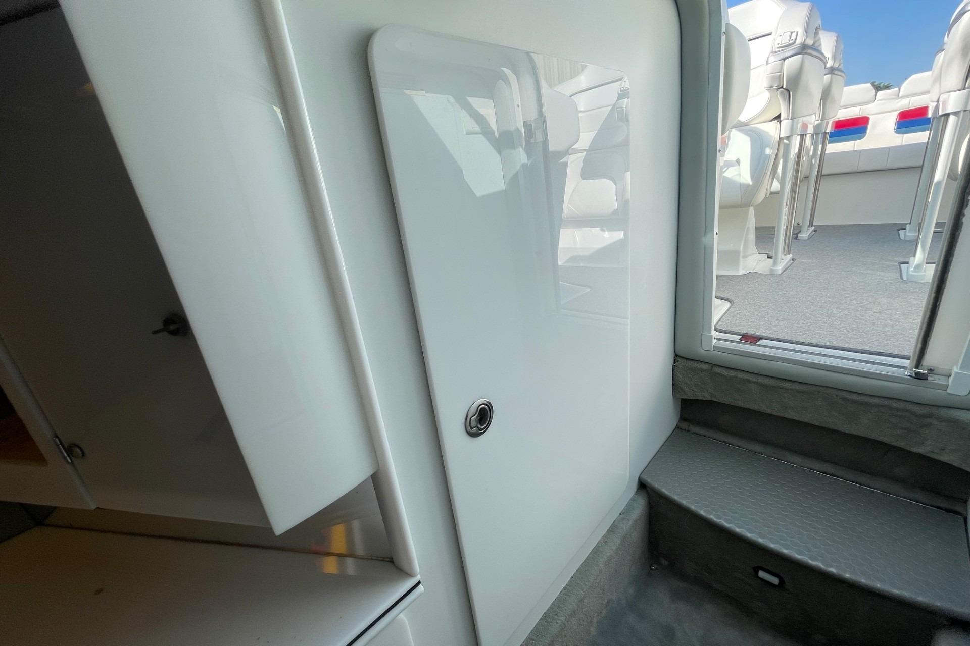 Interior view of a 2004 Formula 382 FASTech boat, featuring sleek white cabinetry and seating.