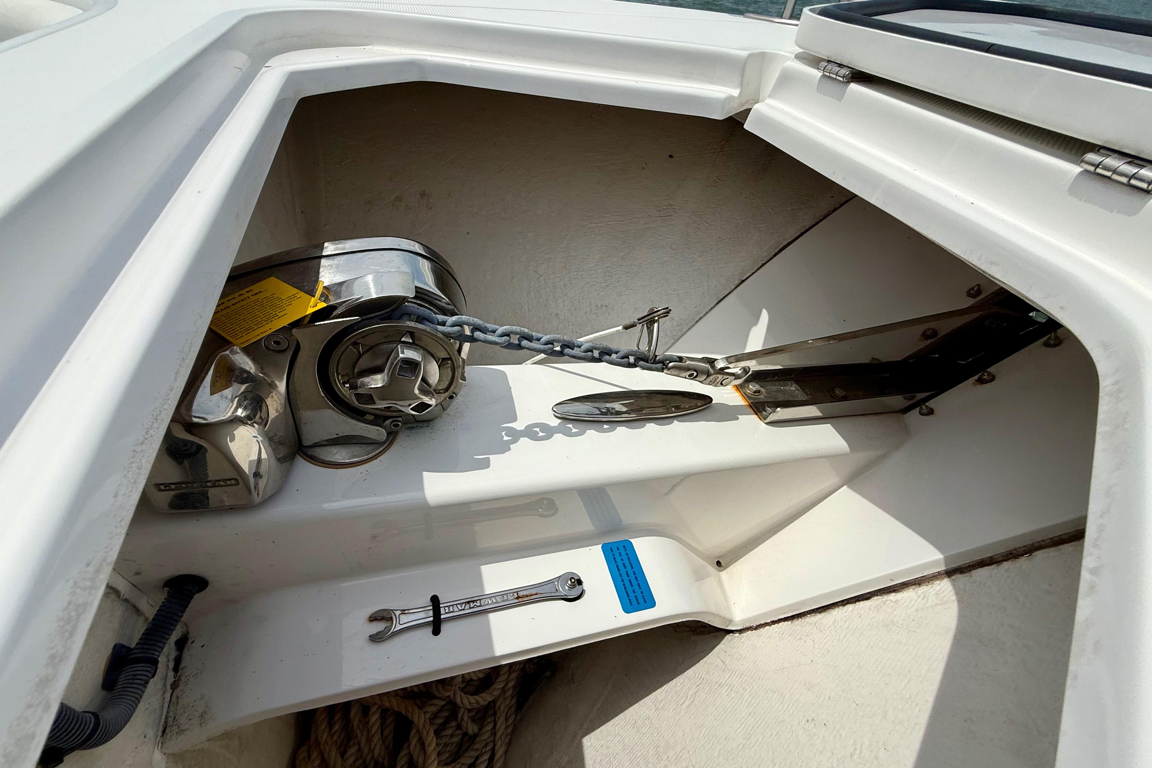 Anchor compartment of 2017 Southport 33 FE boat with chain and tools.