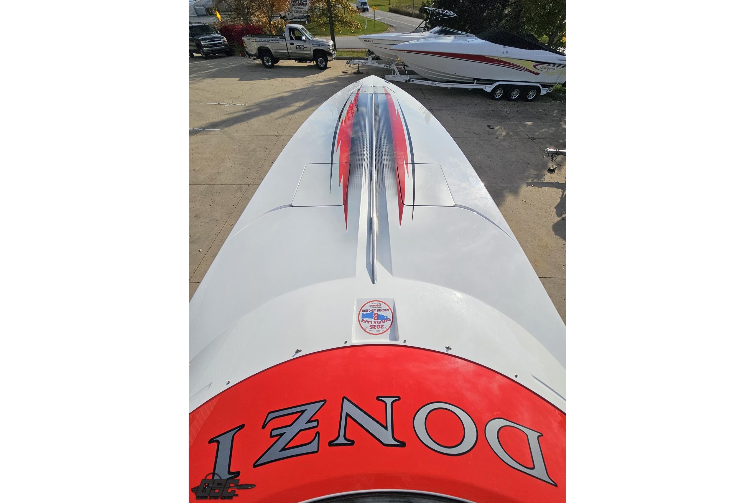 2008 Donzi 38 ZR speedboat with red and black accents, parked outdoors.
