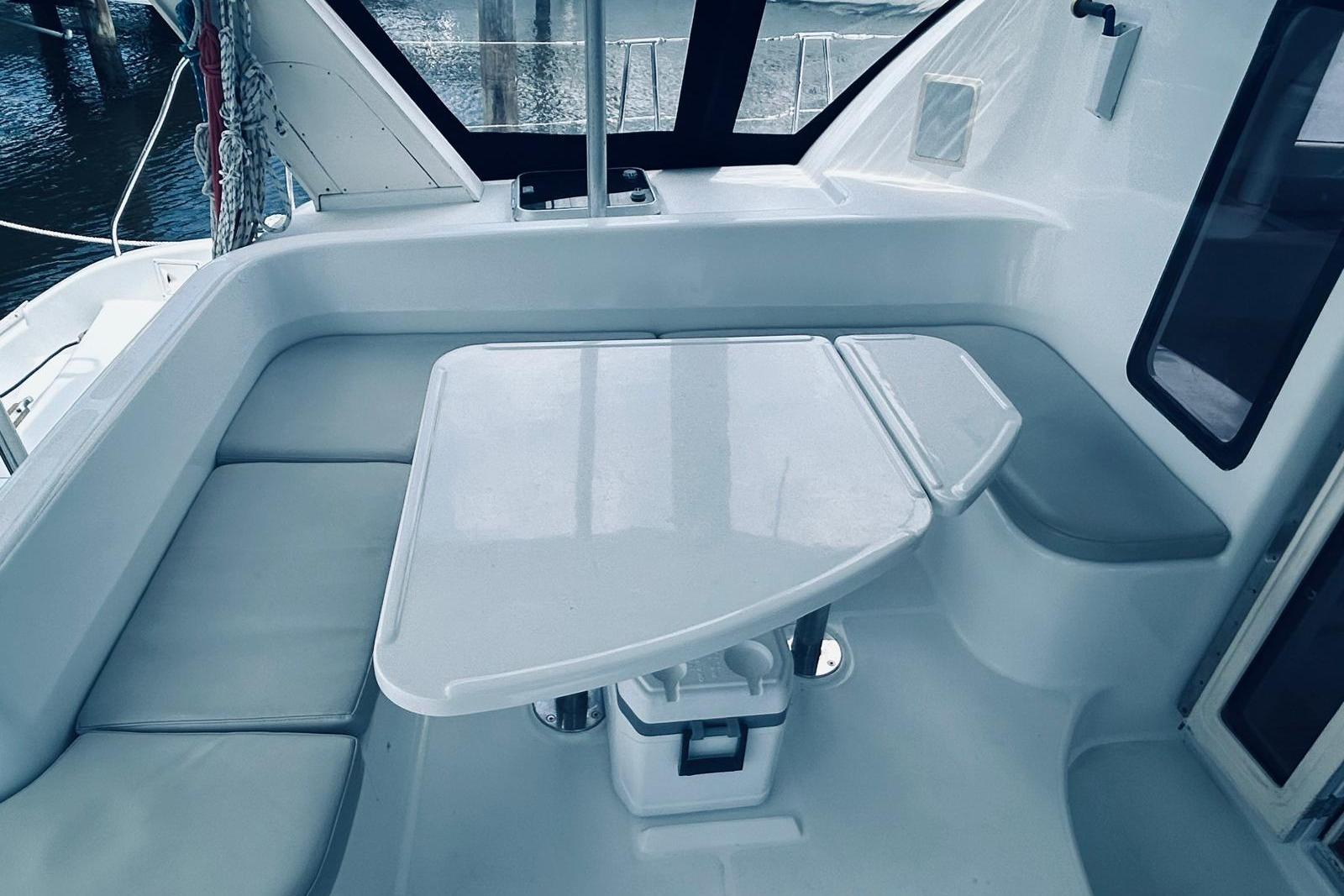 2001 Robertson & Caine Leopard yacht interior with sleek seating and table arrangement.