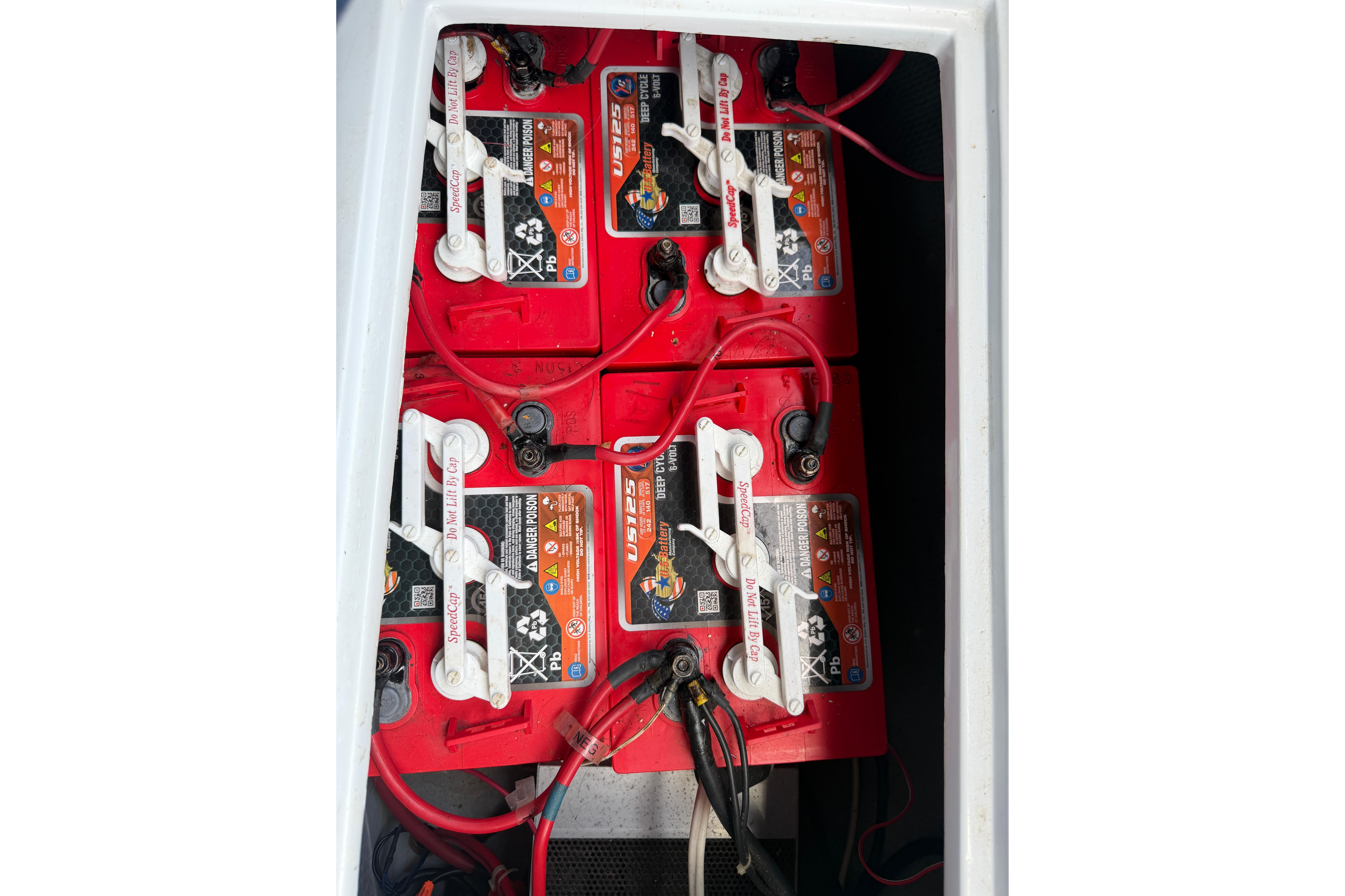 Red batteries in a 1996 Duffy Classic 21 boat compartment.