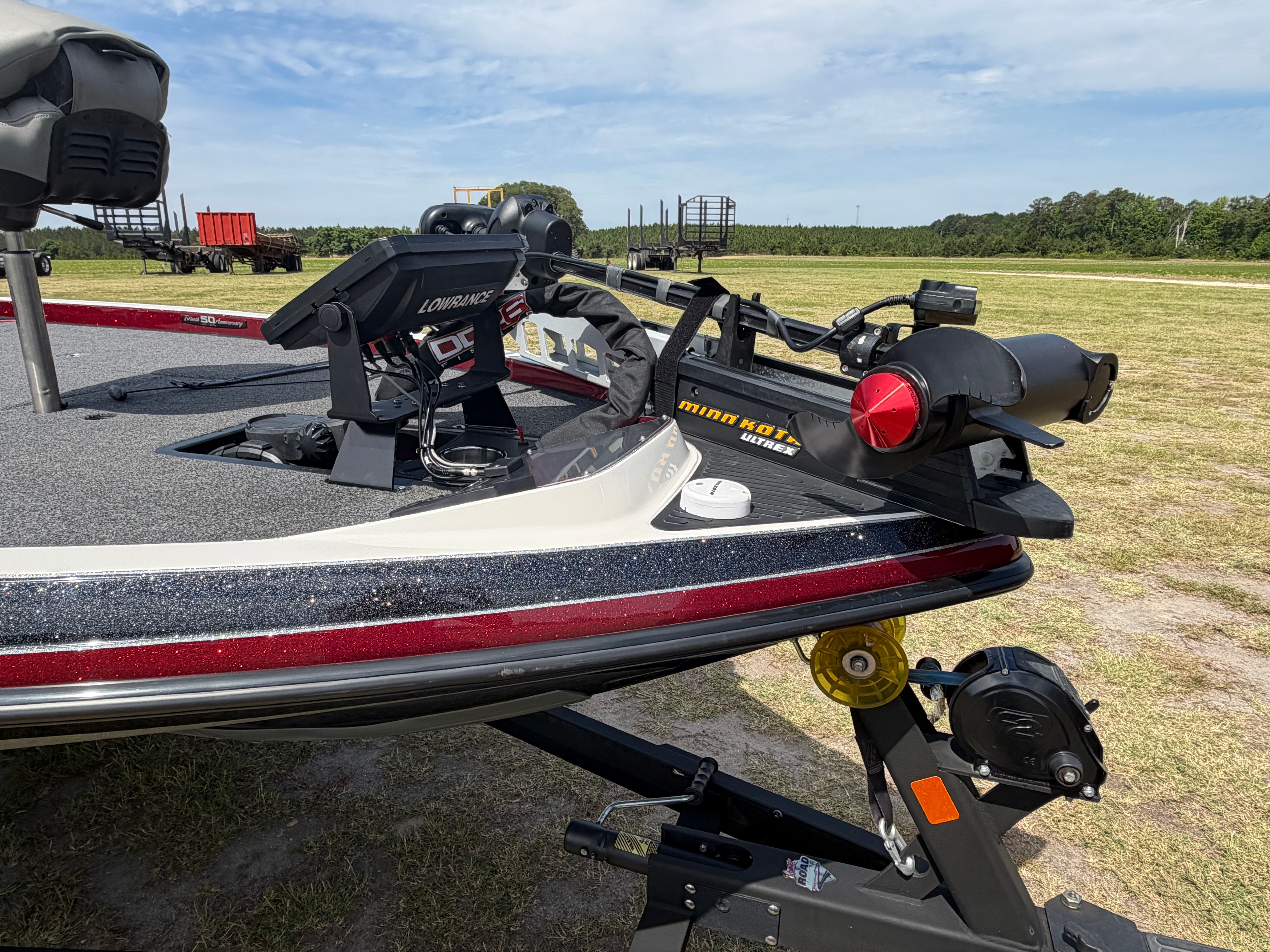 A Ranger 521C boat on a trailer in a grassy area.