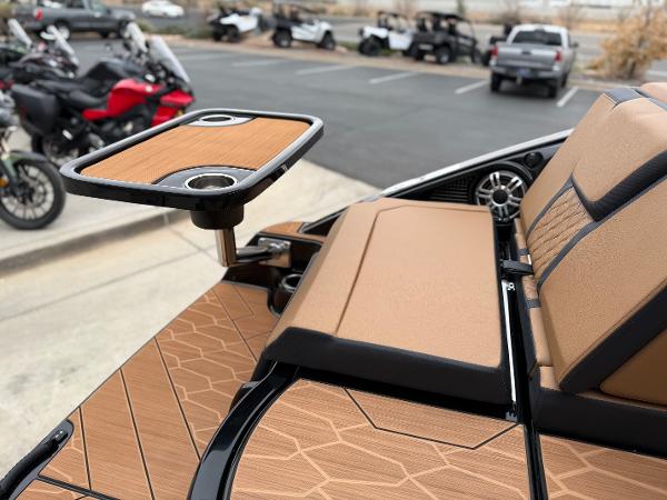 2025 Yamaha Boats 255XD interior with tan seating and a mounted table.