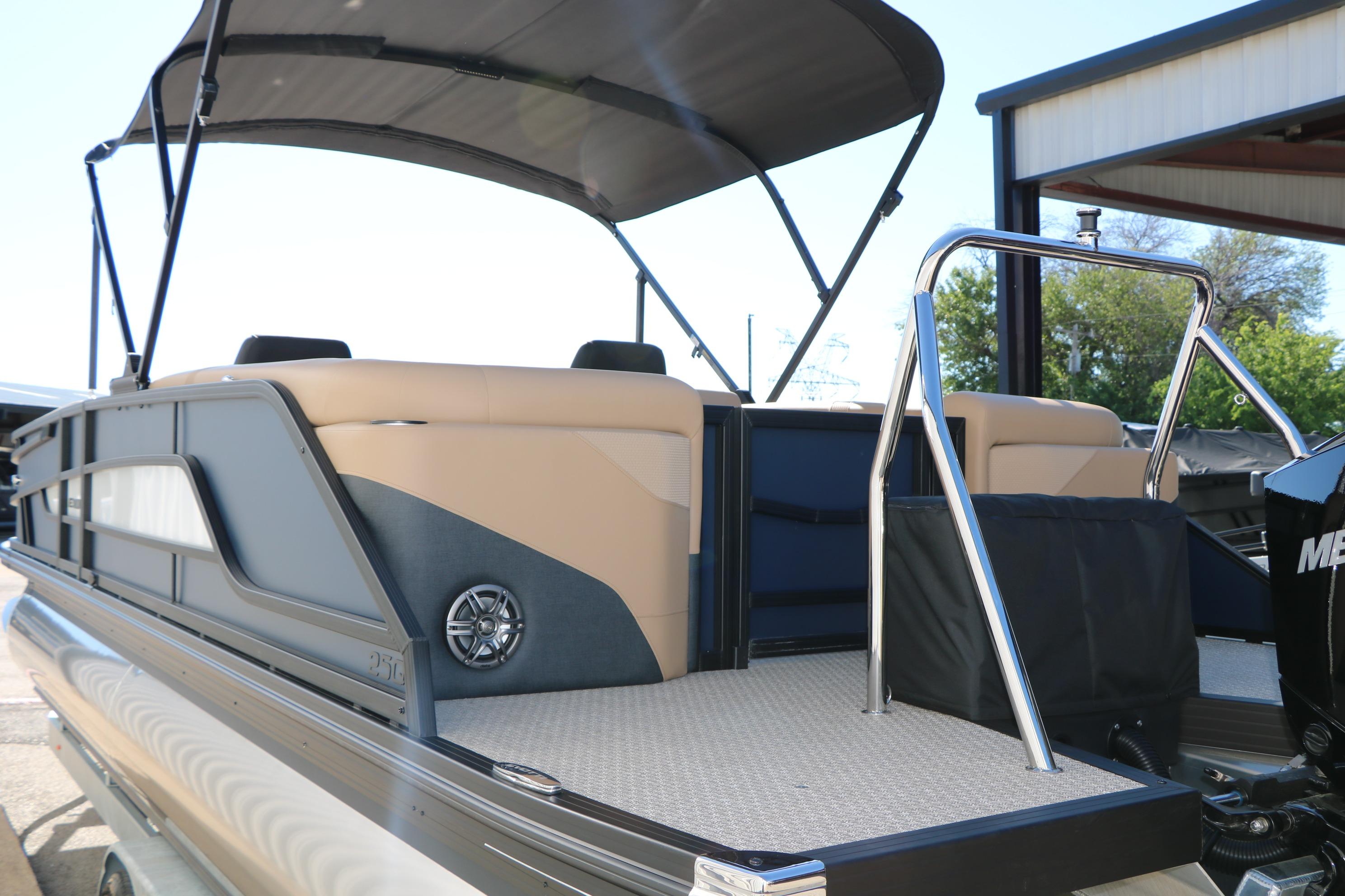 2026 Evotti 525 QL Tri-Toon boat with canopy and sleek design, docked outdoors.