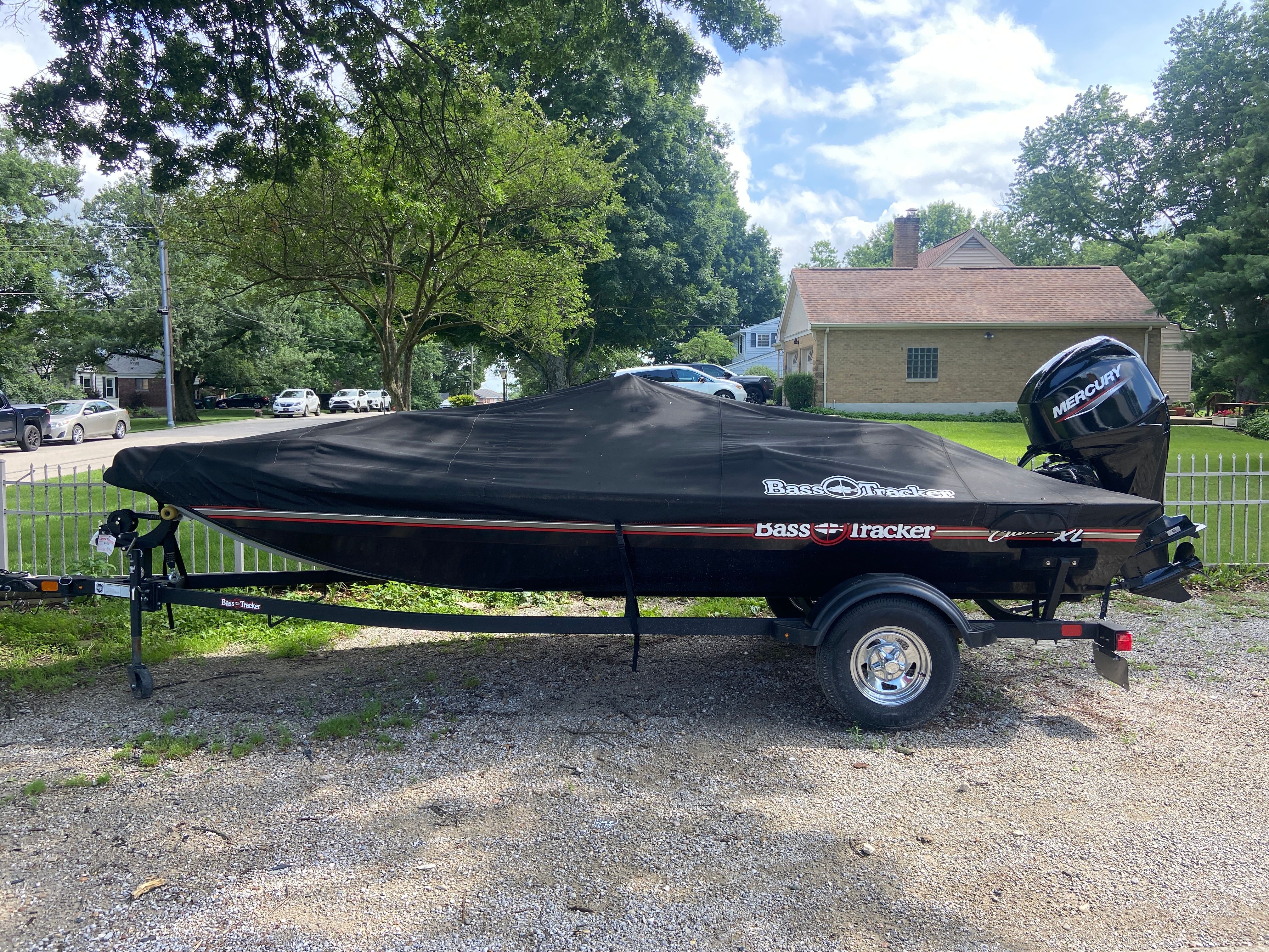 A 2024 Bass Tracker 50ELPT boat on a trailer, covered and ready for transport.