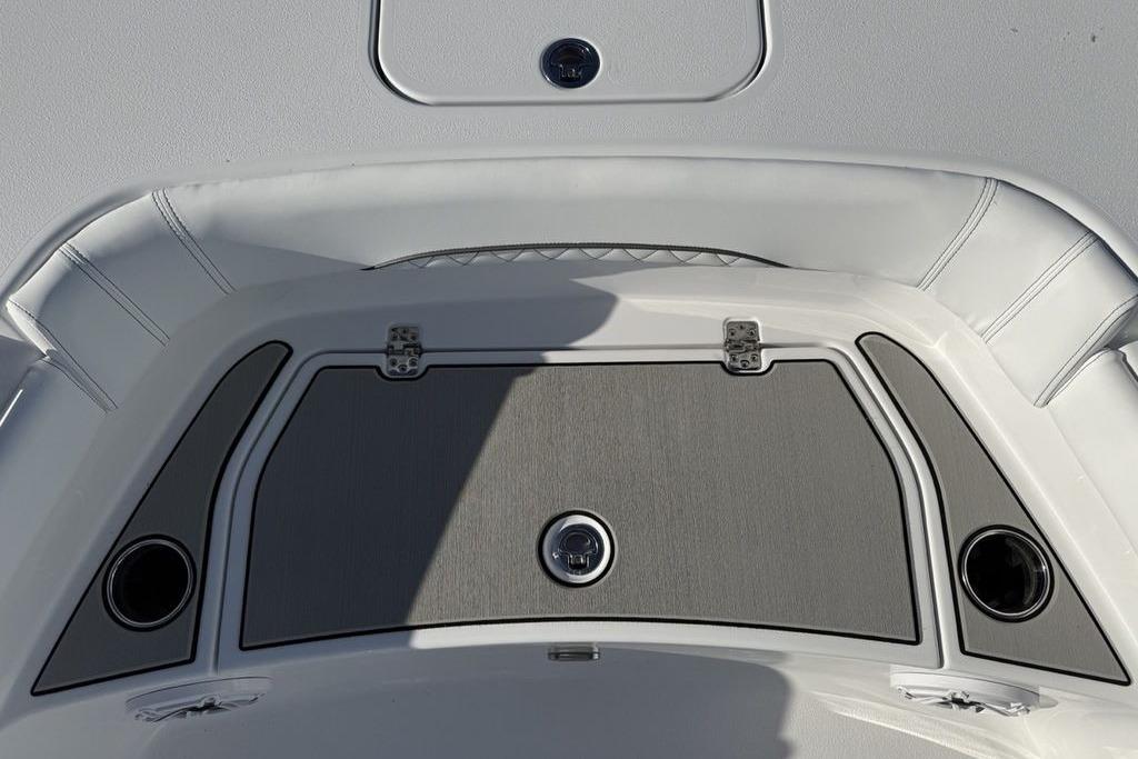 2026 Sportsman Masters 247OE Bay Boat deck with storage compartment and cup holders.