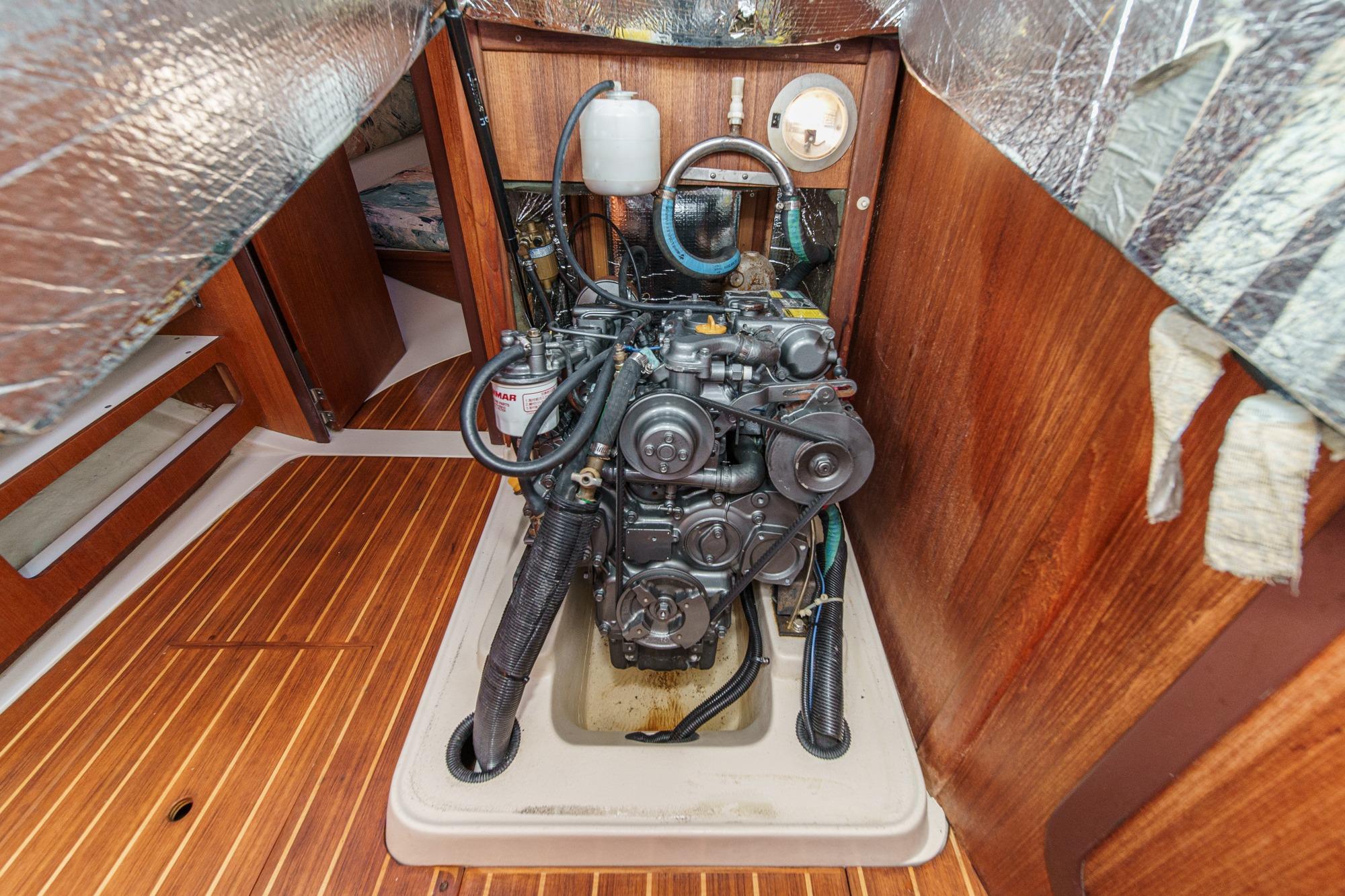 Engine compartment of a 1996 Hunter 376 sailboat, featuring a well-maintained marine engine.