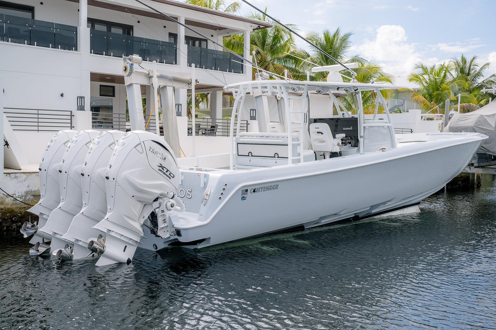 2024 Contender 44 ST boat docked, featuring four powerful outboard engines.