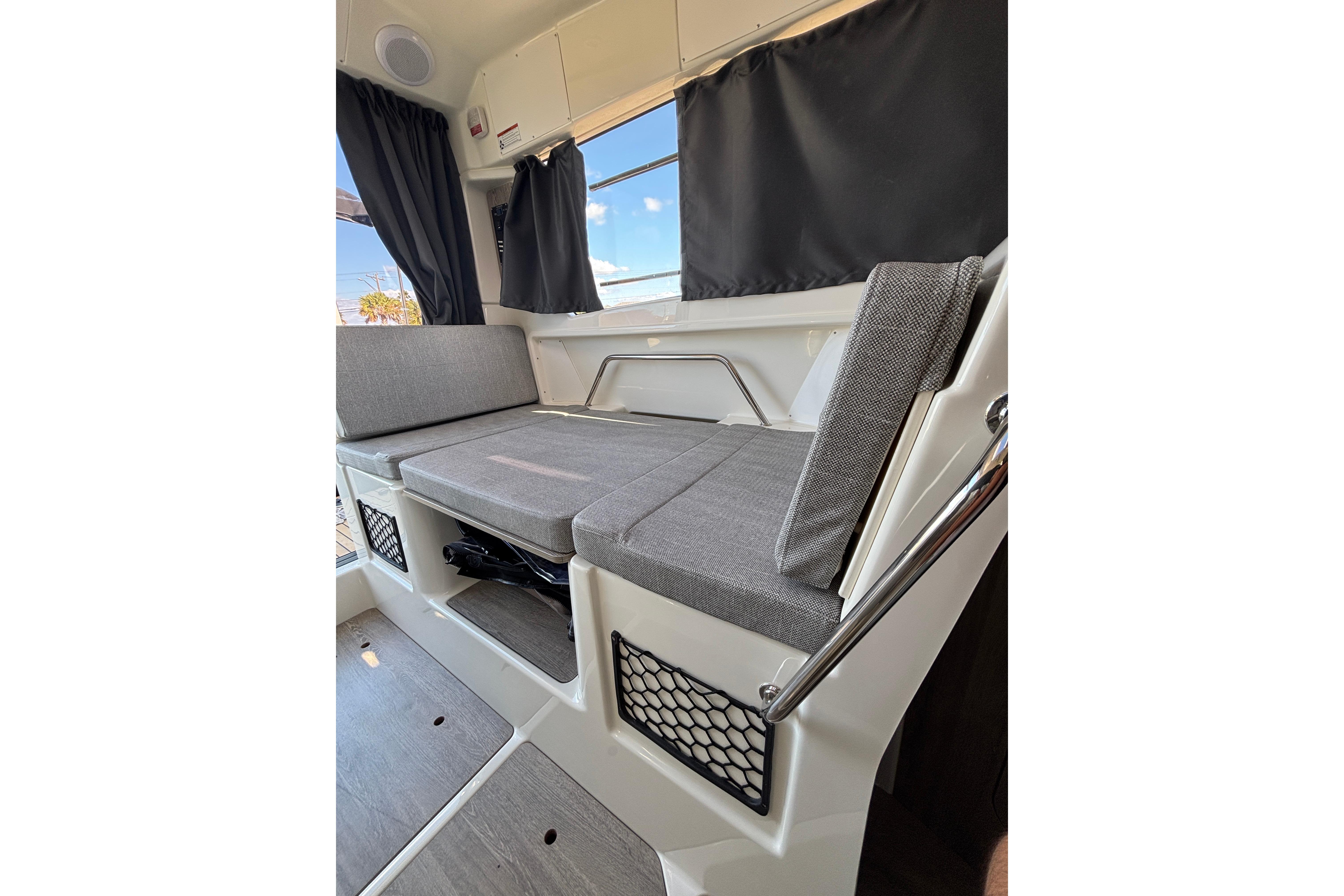 Interior of 2026 Trophy T 25 Explorer boat with gray seating and curtains.