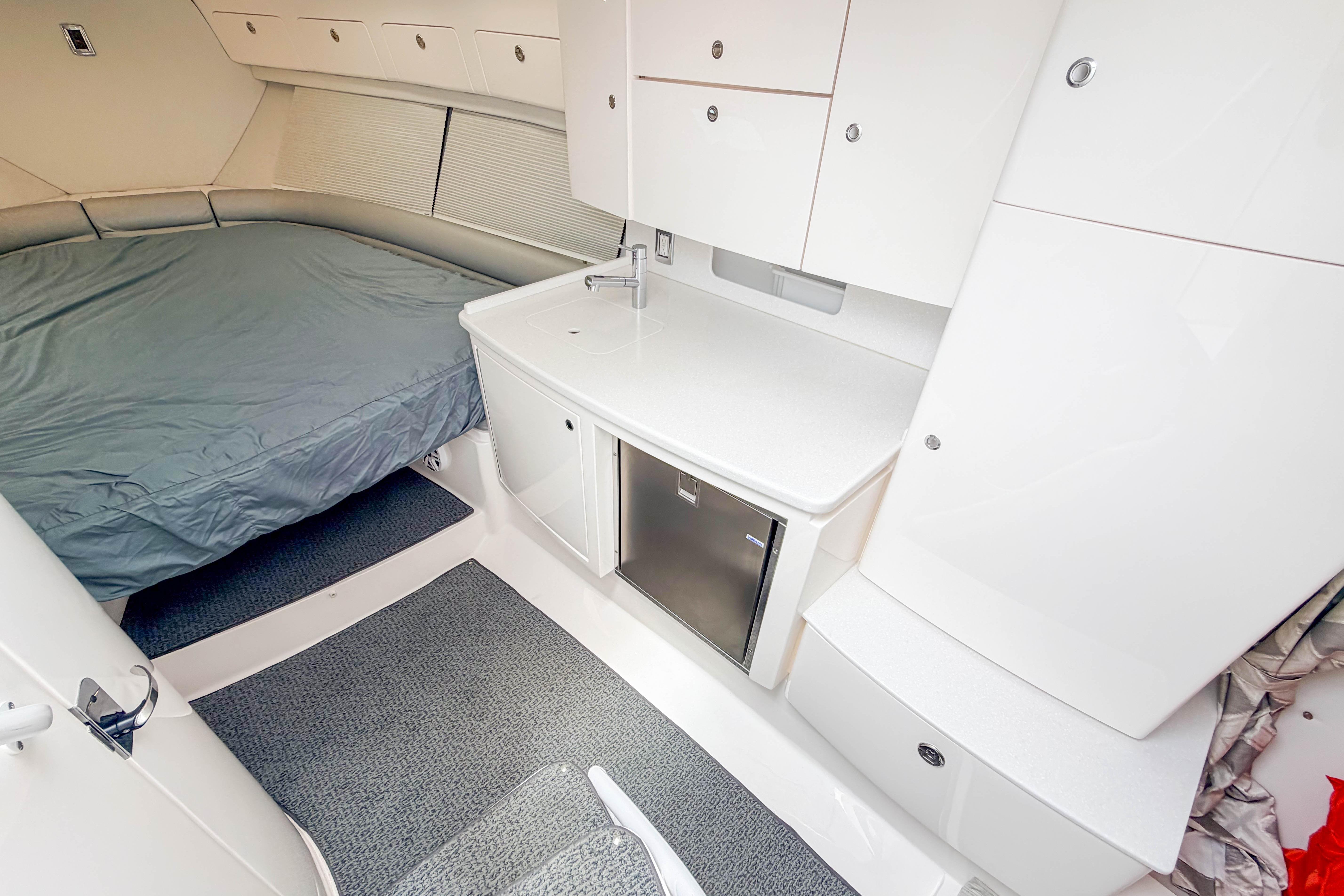2021 Intrepid 409 Valor cabin interior with bed, kitchenette, and storage cabinets.
