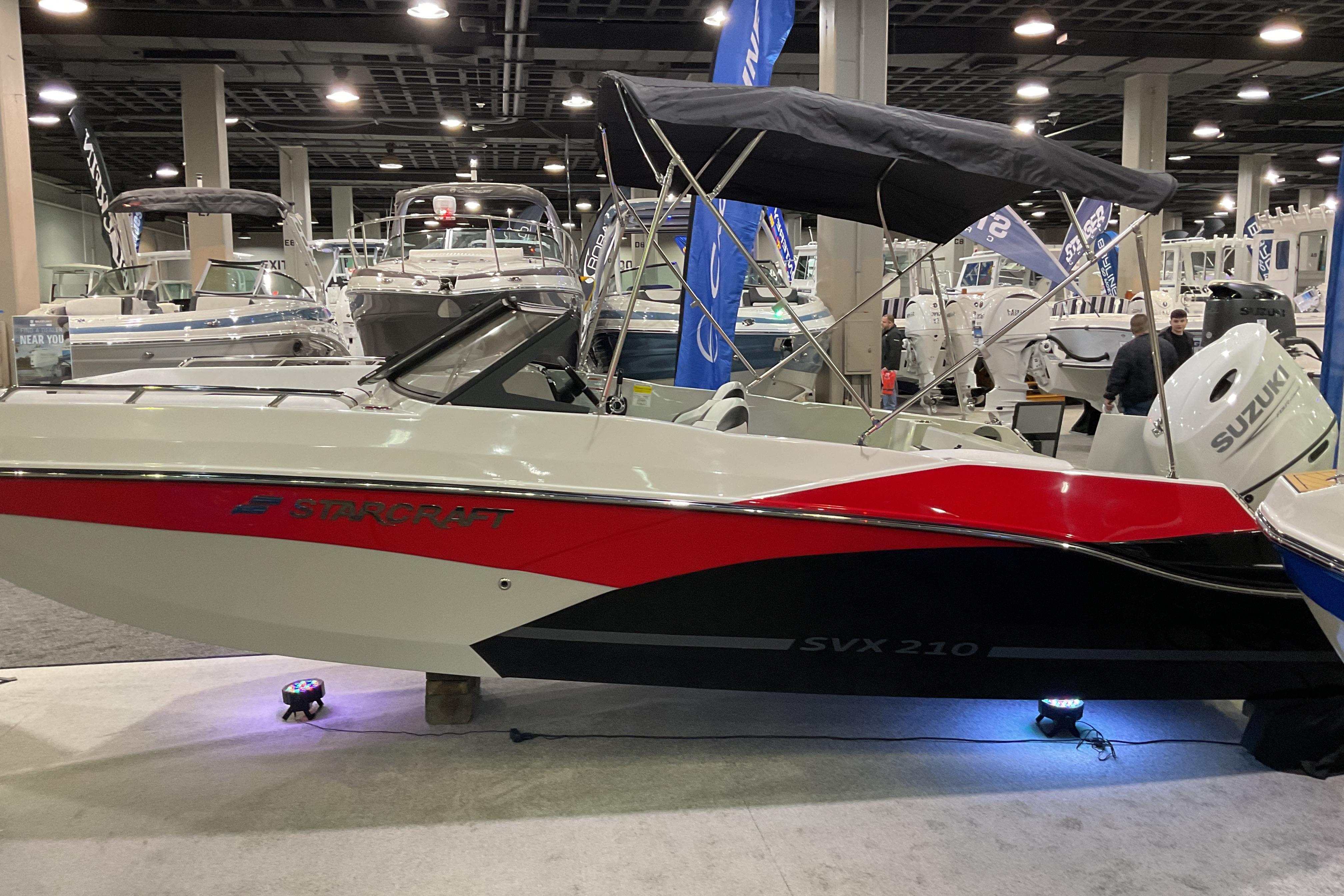 2026 Starcraft SVX 210 DC OB boat displayed at an indoor boat show.