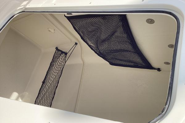2022 Sailfish 220 CC storage compartment with netting for secure storage.