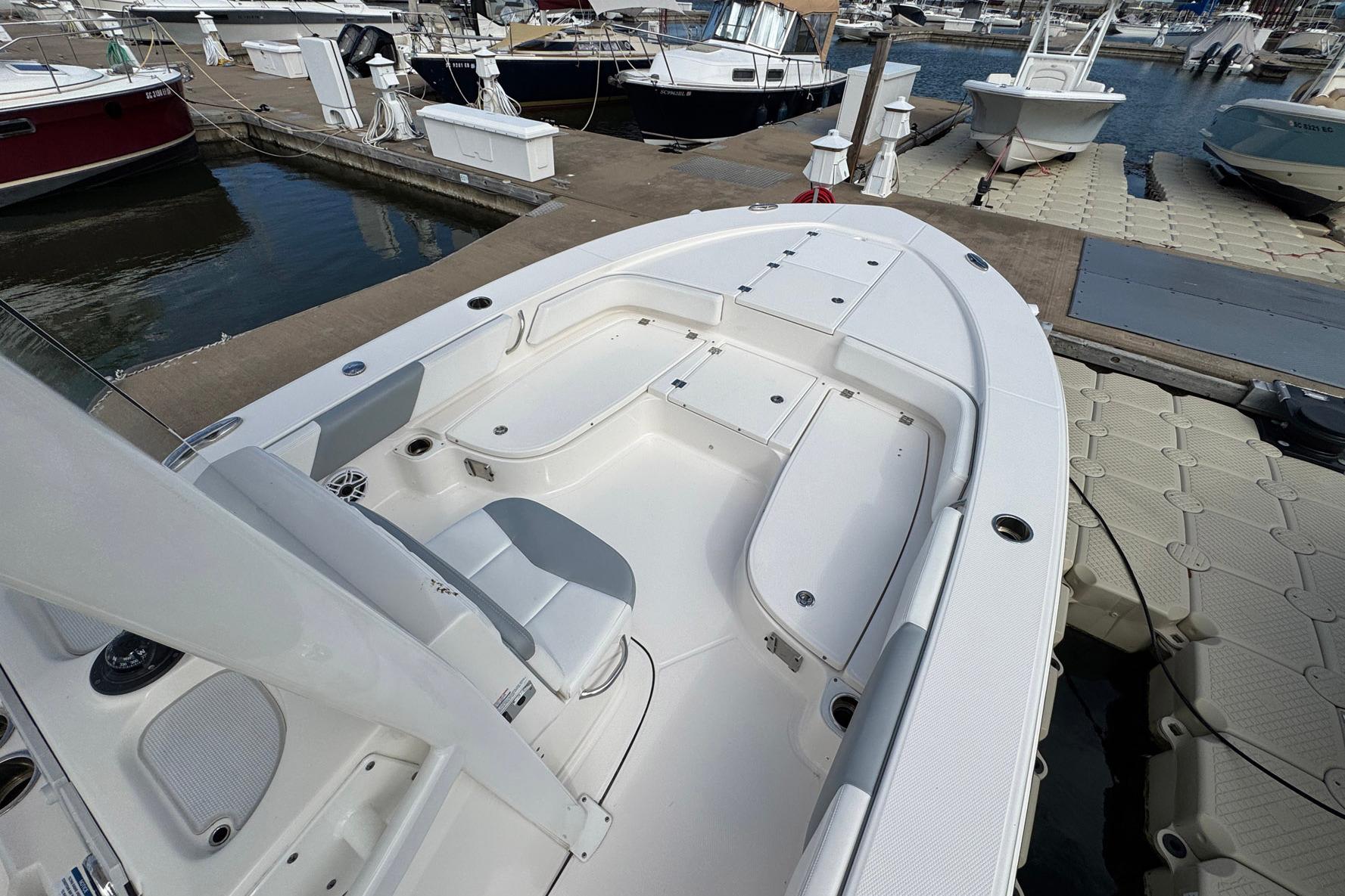2021 Robalo 246 Cayman boat docked at marina, showcasing spacious seating and storage.