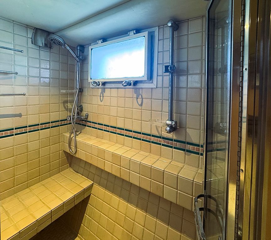 Tiled shower with window on a 1961 Burger 63 yacht.