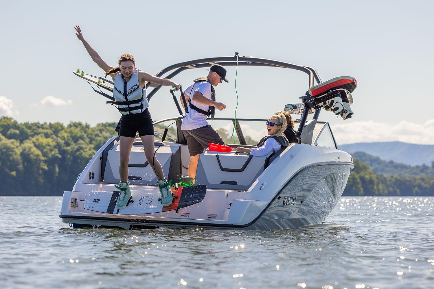 Manufacturer Provided Image: 2026 Yamaha Boats AR220 on lake with people enjoying water activities.