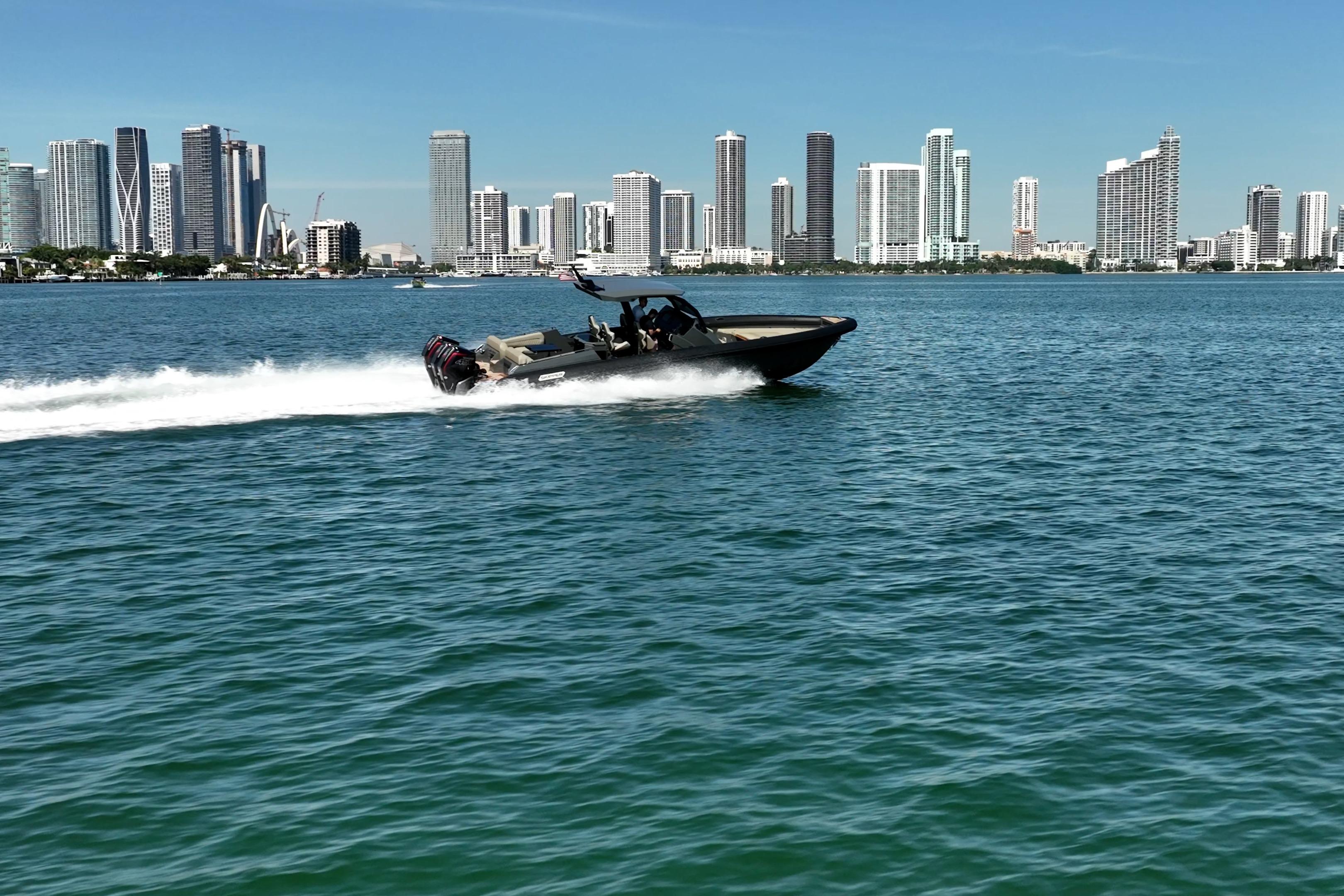 Speedboat Skipper-BSK 38NC cruising near city skyline, 2023 model.