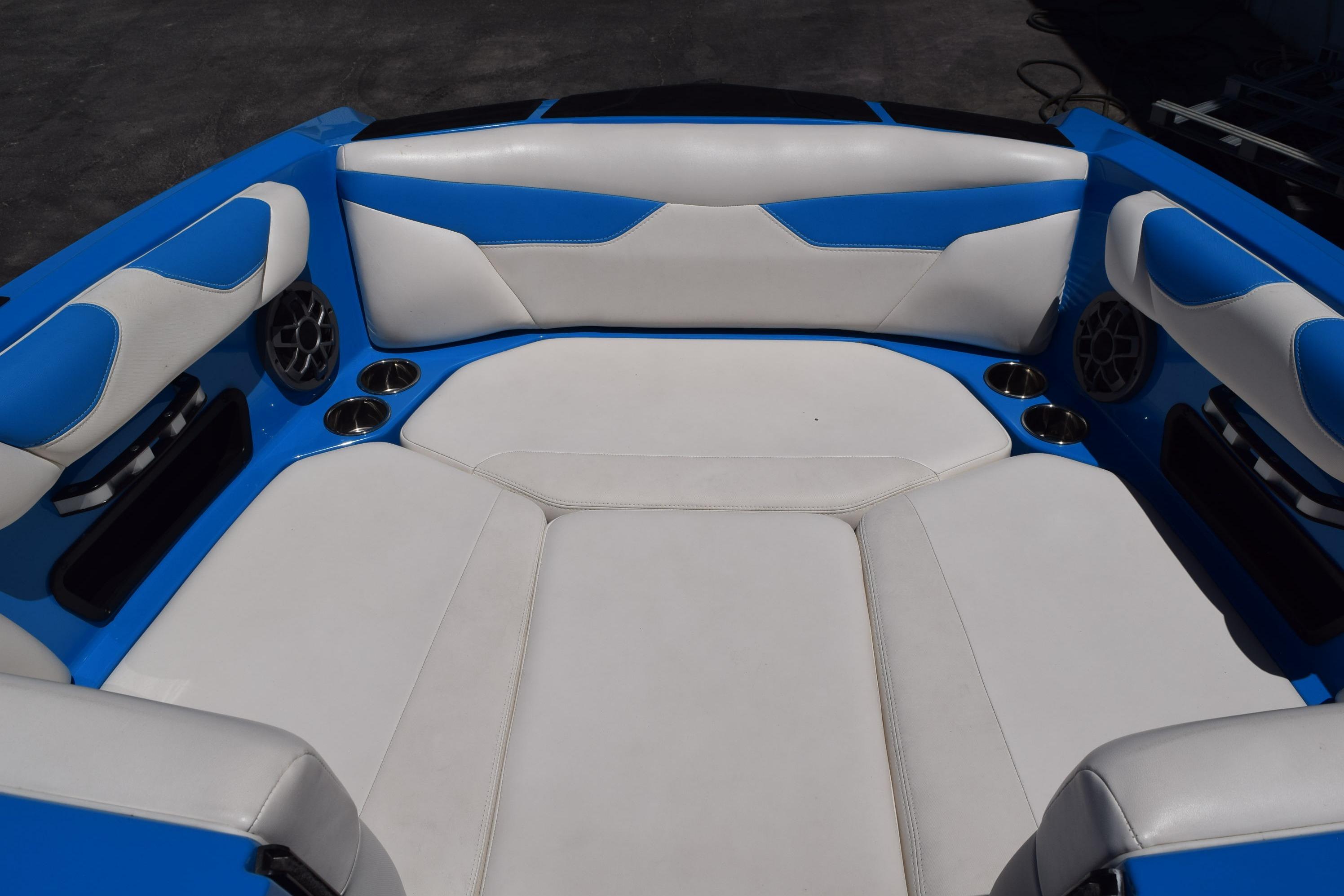 2019 Axis A22 boat interior with blue and white seating, cup holders, and speakers.