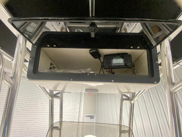 2024 Key West 219 FS boat console storage with electronic equipment.