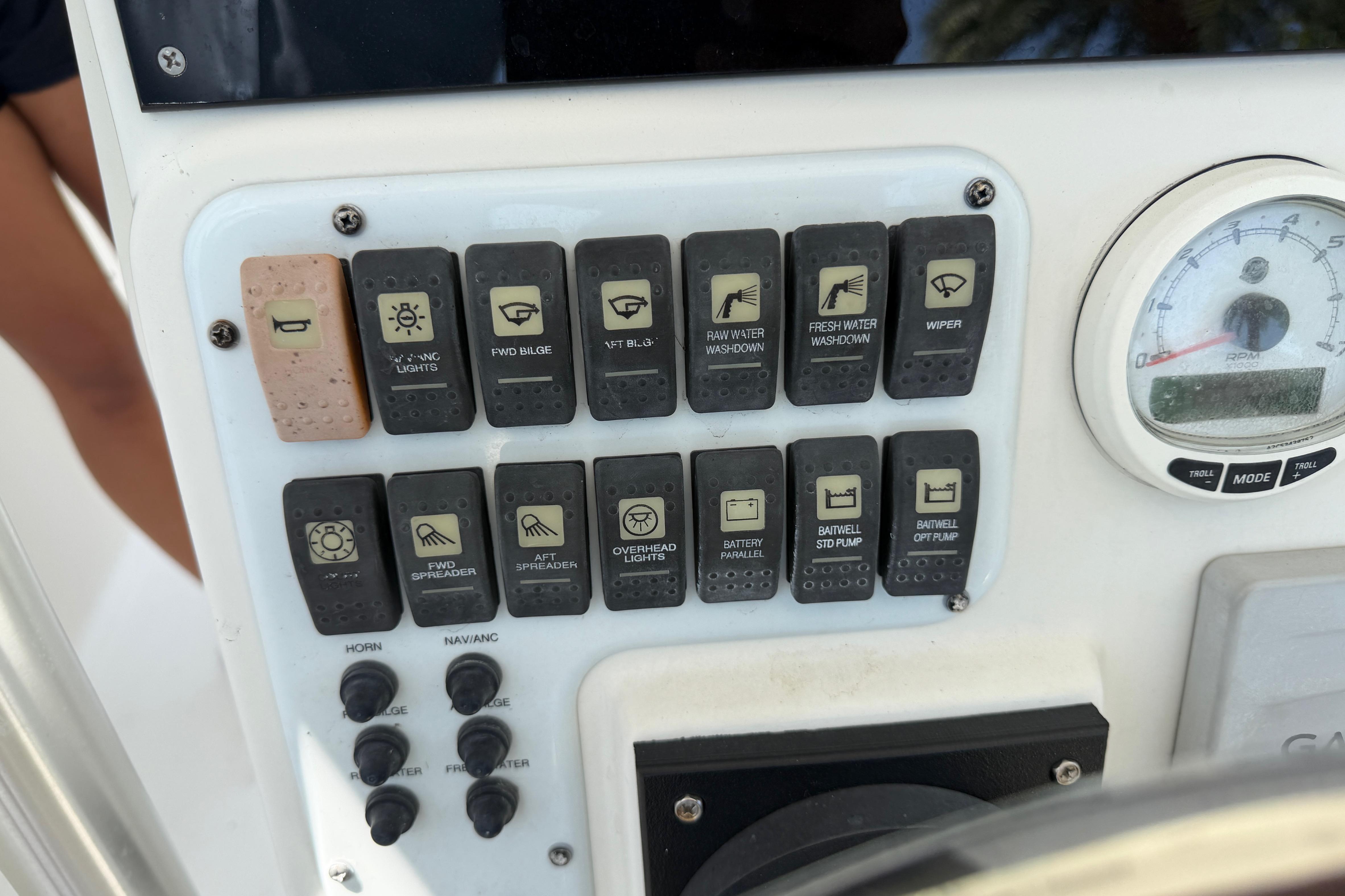 Control panel of a 2008 Hydra-Sports Vector 2900 CC boat with various switches and a gauge.