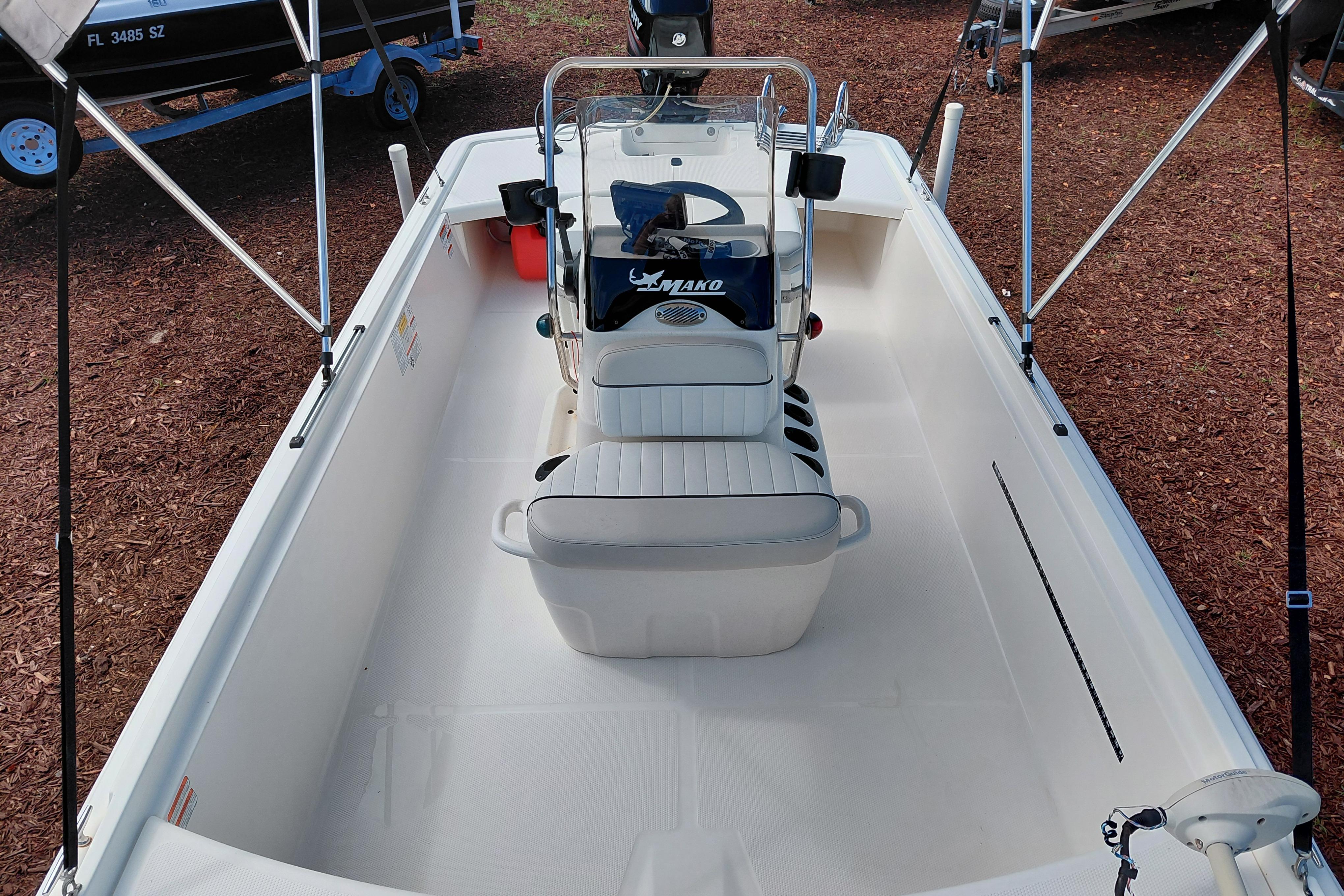 2015 Mako Pro Skiff 17 CC boat interior with seating and steering console.