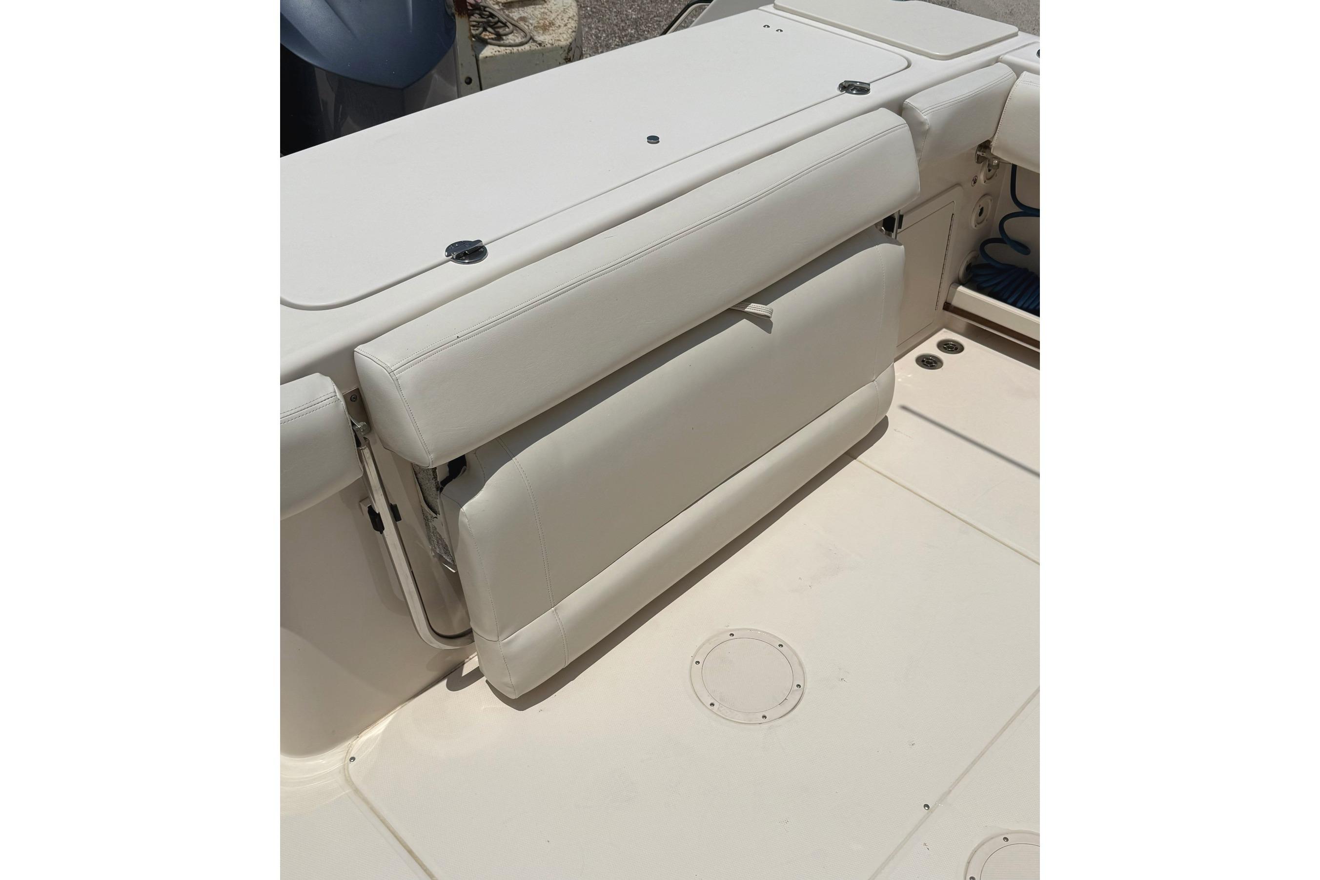 2018 Grady-White Canyon 306 boat with foldable white seat on deck.