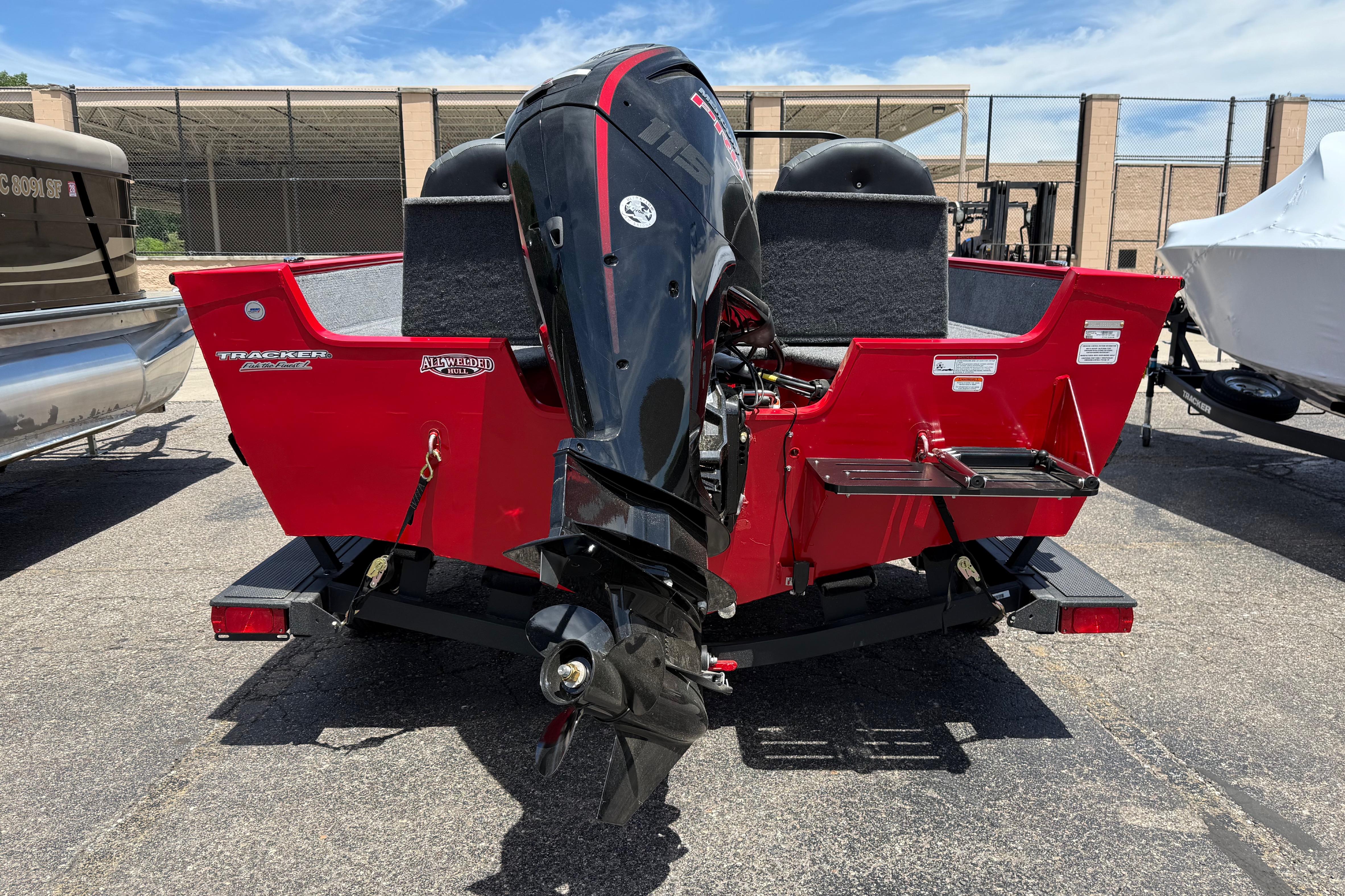 2026 Tracker Pro Guide V-175 Combo boat with powerful outboard motor, parked outdoors.