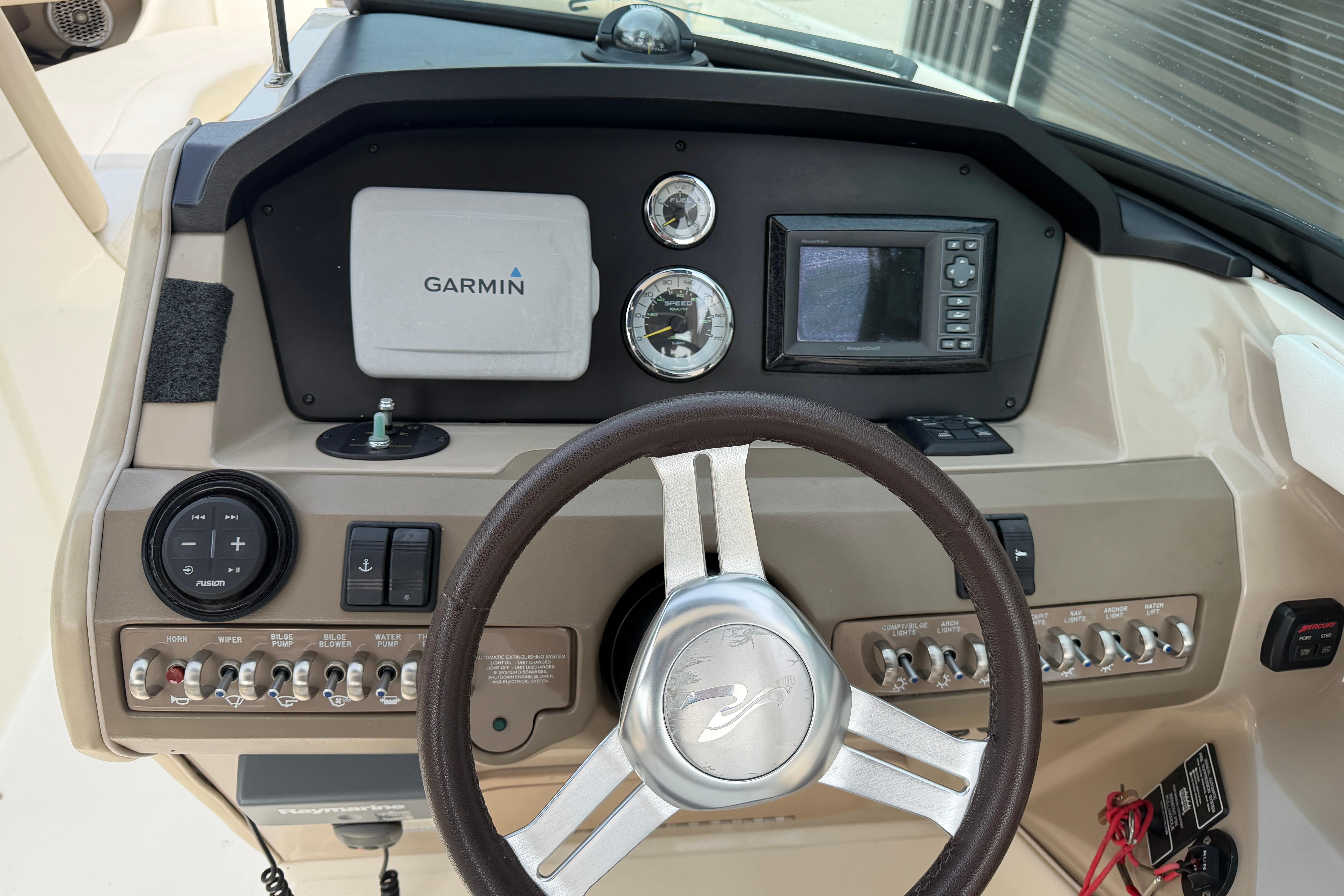 Dashboard of a 2013 Sea Ray 300 SLX boat with Garmin navigation system.