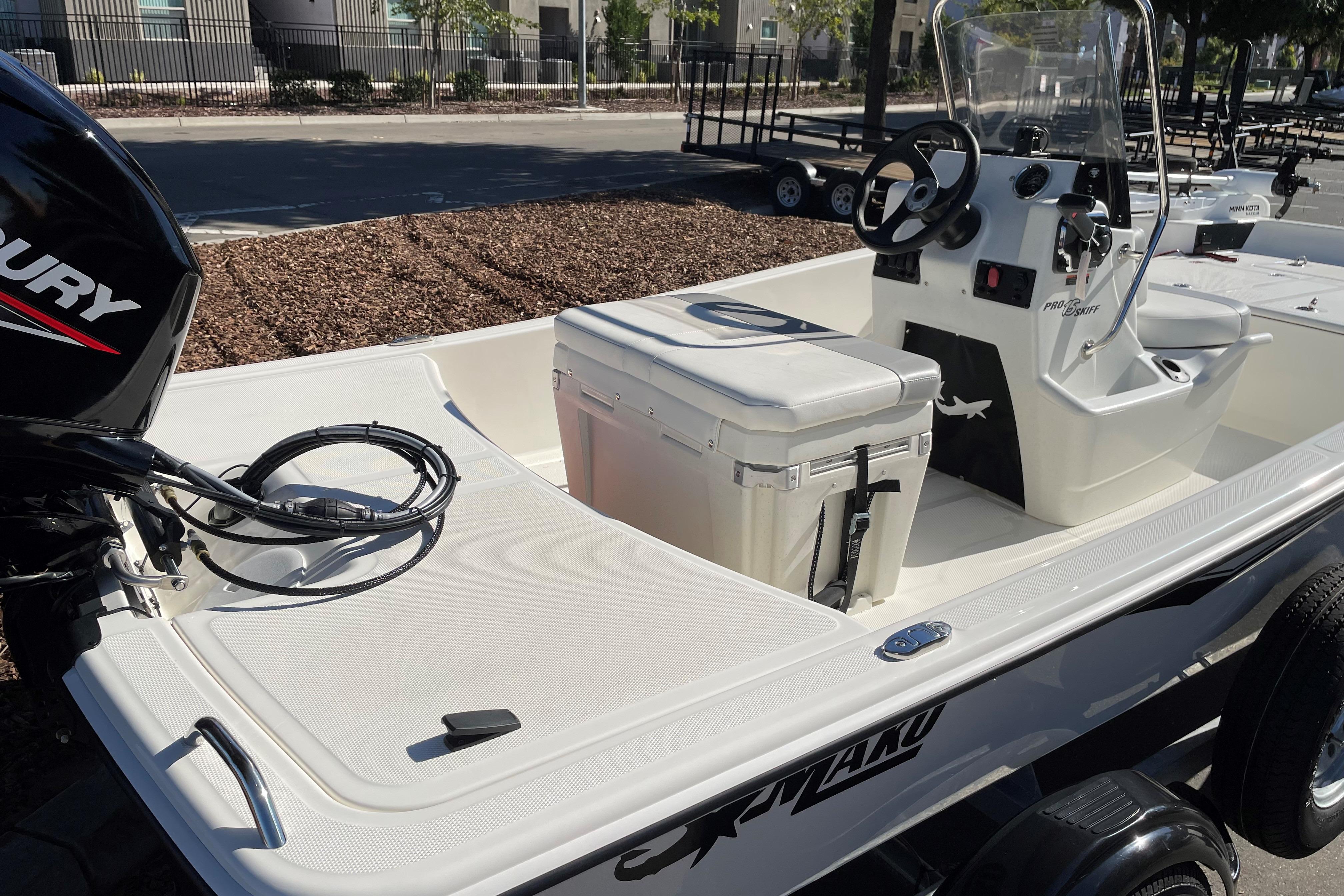2025 Mako Pro Skiff 15 CC boat with Mercury engine, featuring center console and seating.