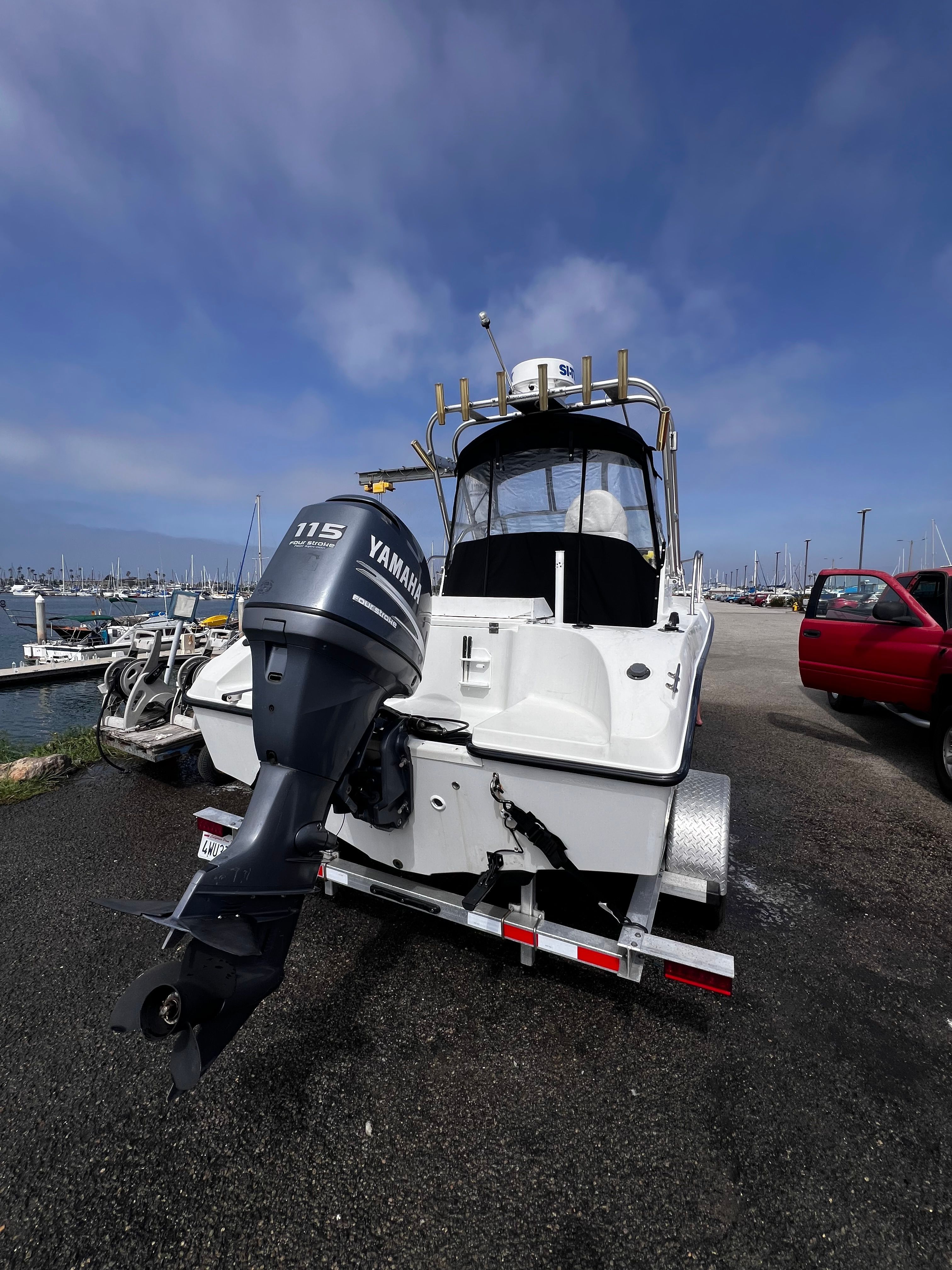 A 2001 Seaswirl Striper 1851 WA with Yamaha outboard motor on a trailer at the harbor.