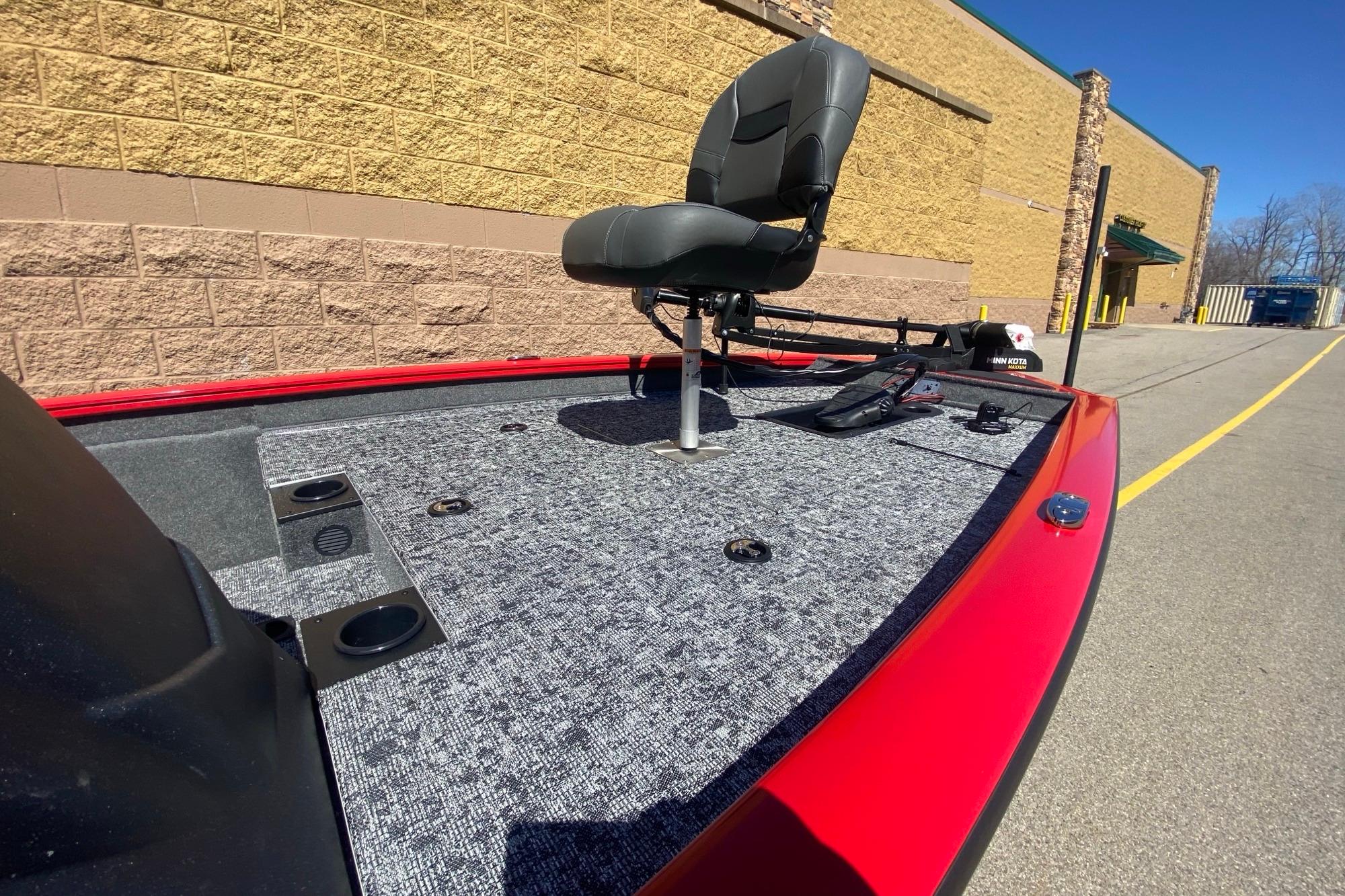 2026 Tracker Pro Team 175 boat deck with seat, red trim, and carpeted surface.