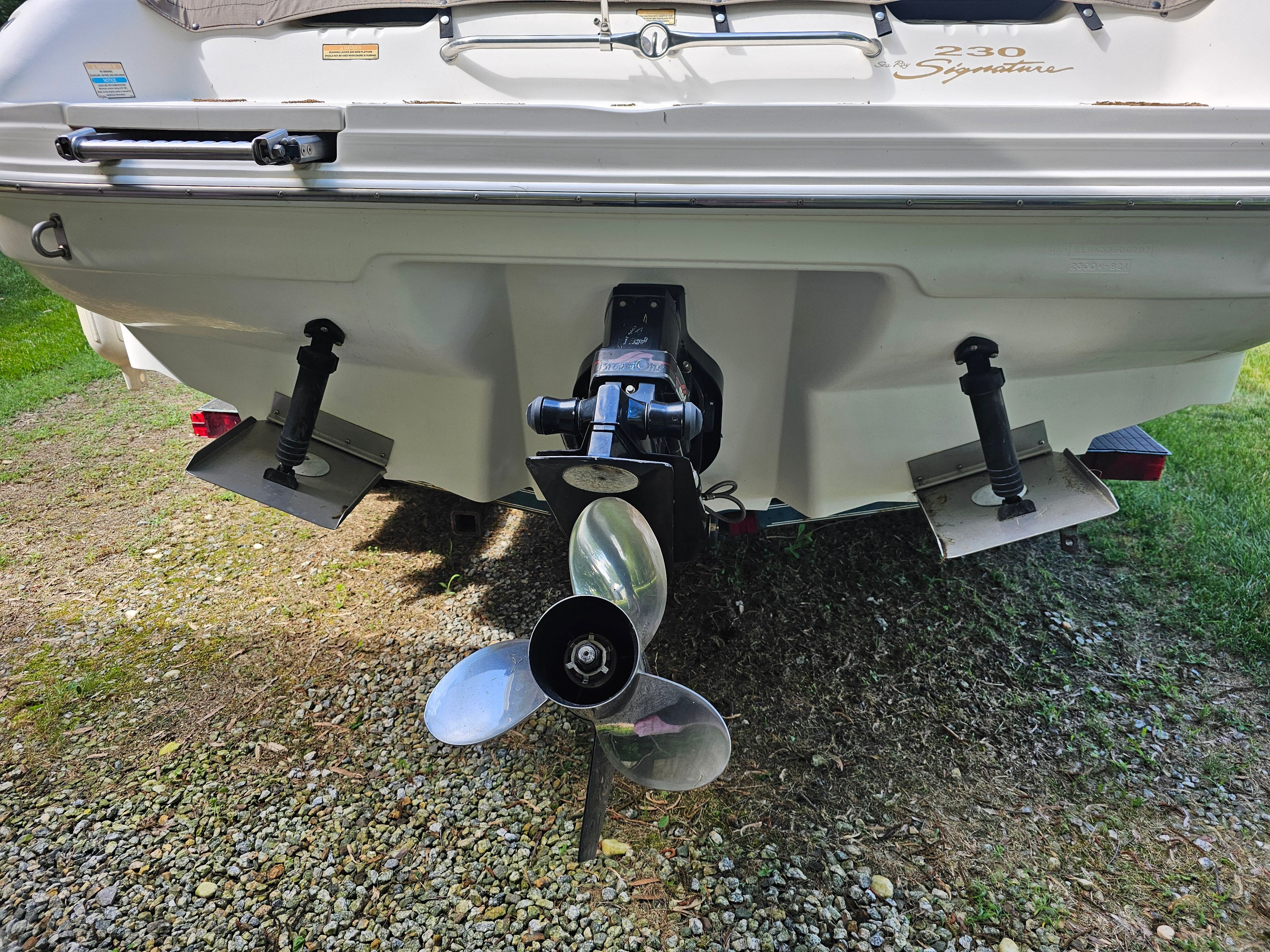 Rear view of a 1997 Sea Ray 230 Overnighter Signature on a trailer.