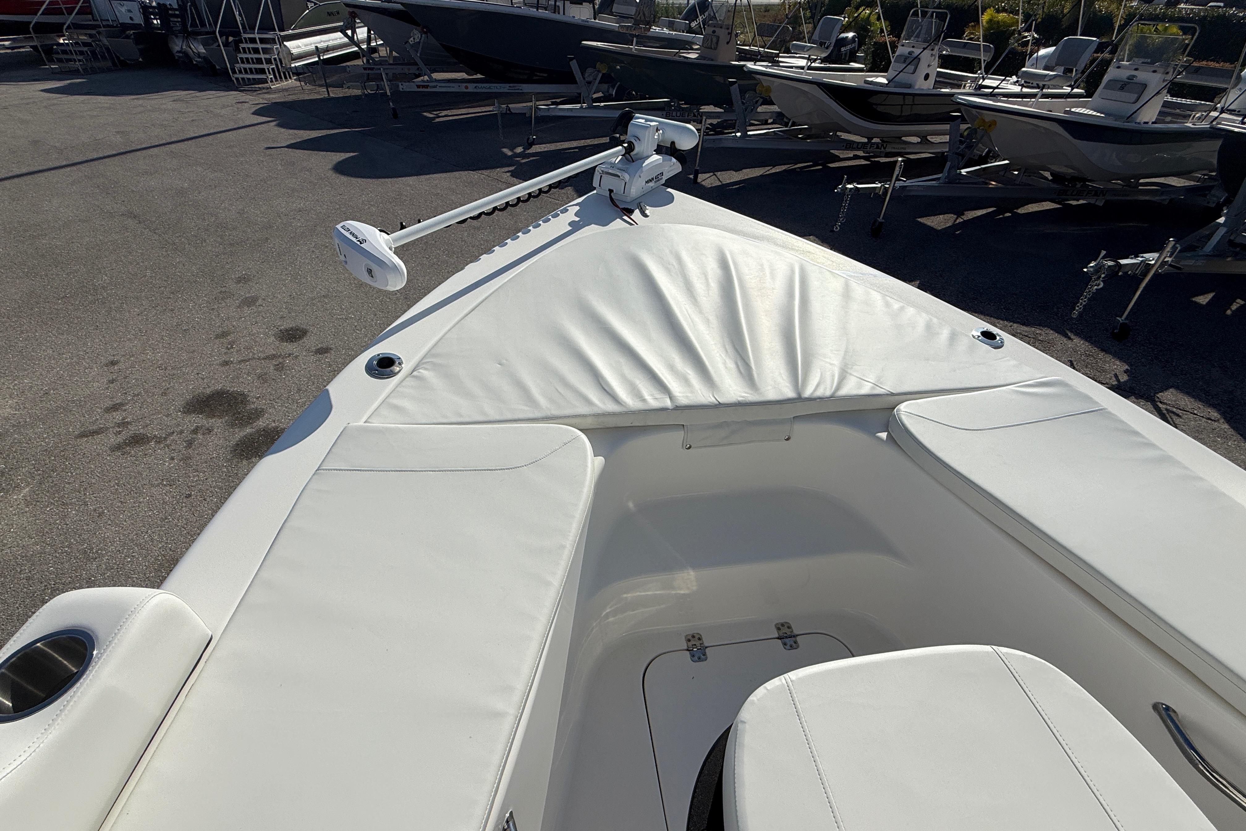 2025 Sea Pro 210 Bay boat interior with white seating and trolling motor.