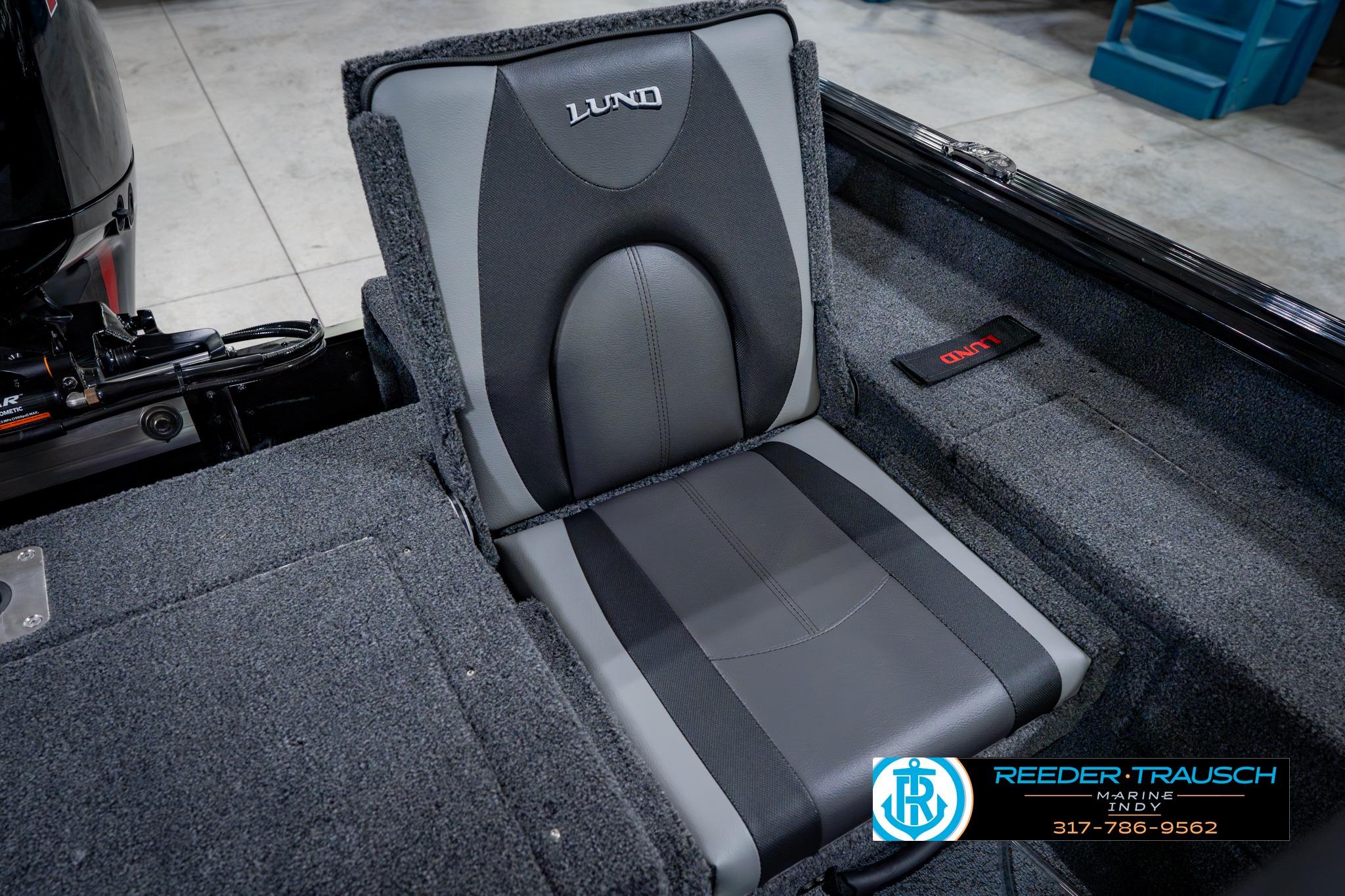 2026 Lund 1875 Impact XS boat seat with gray upholstery and logo detailing.