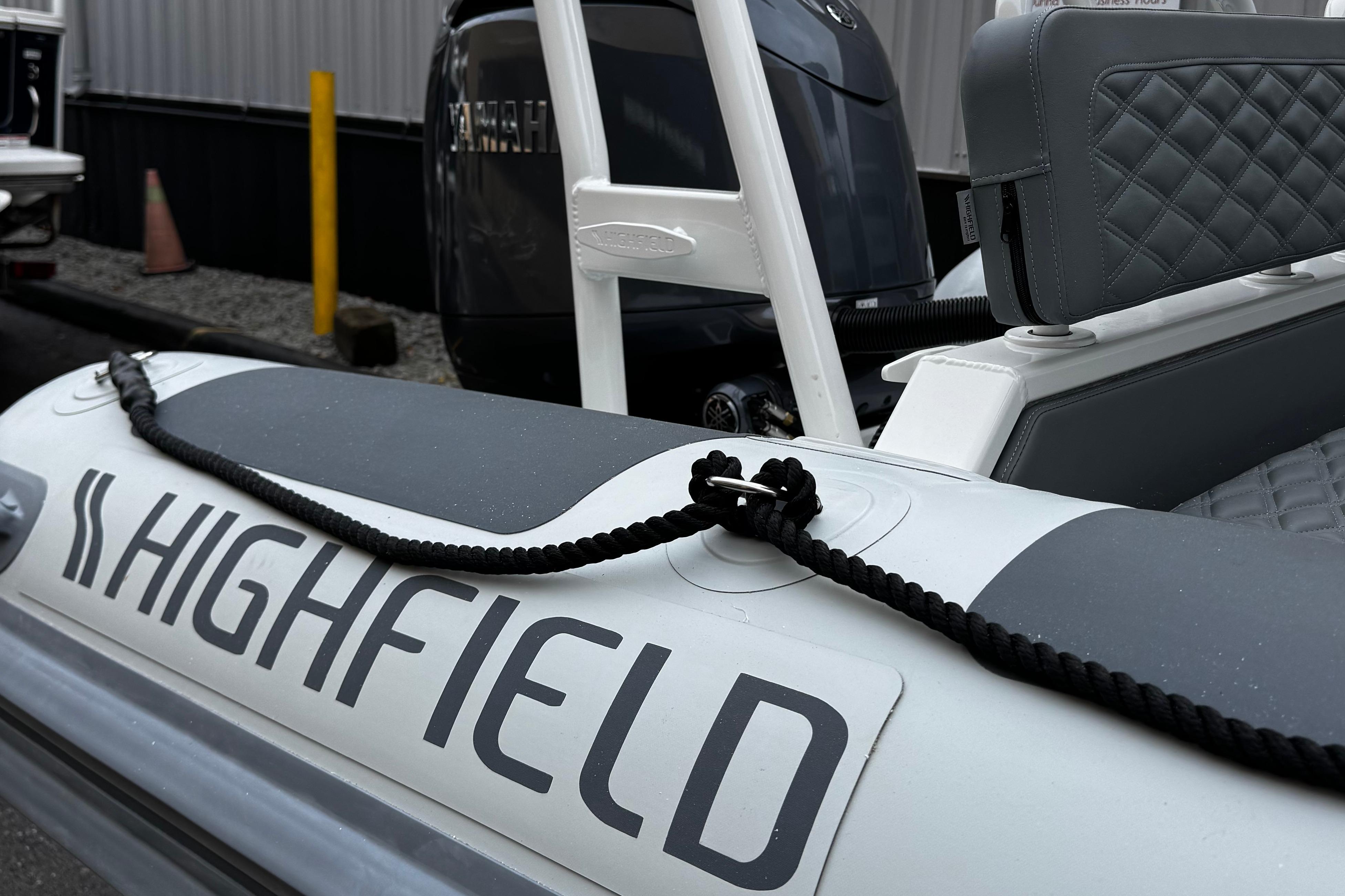 2026 Highfield Patrol 600 boat with Yamaha engine, featuring sleek design and branding.