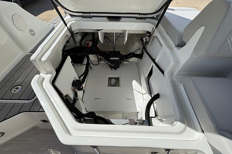 Open storage compartment of 2027 Sea Ray SDX 230 Outboard boat, showcasing interior space.
