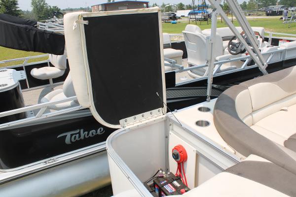 2021 Tahoe LTZ Cruise pontoon boat with open storage compartment and seating area.