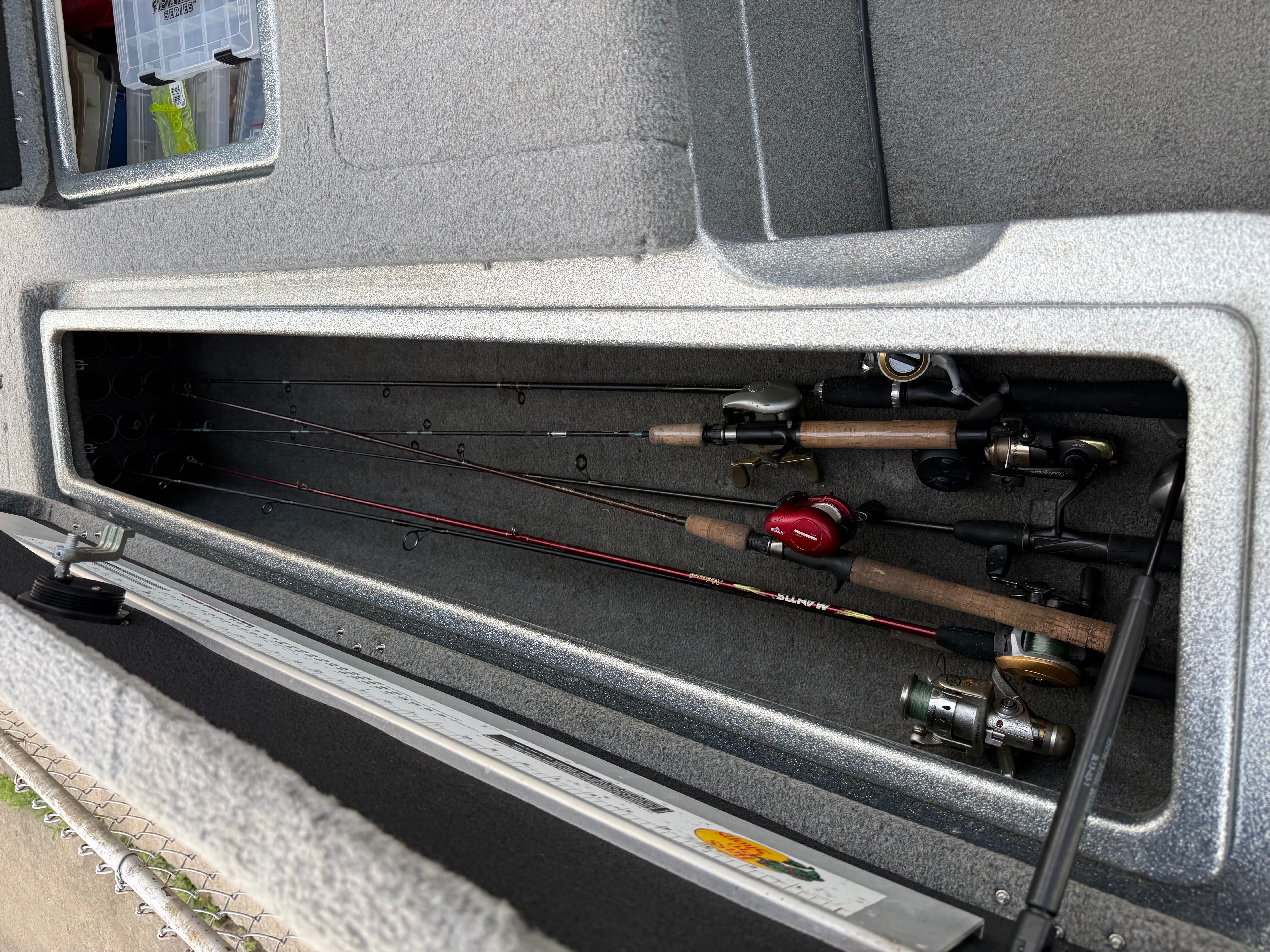 Fishing rods in storage compartment of a 2004 Nitro NX 898 DC boat.