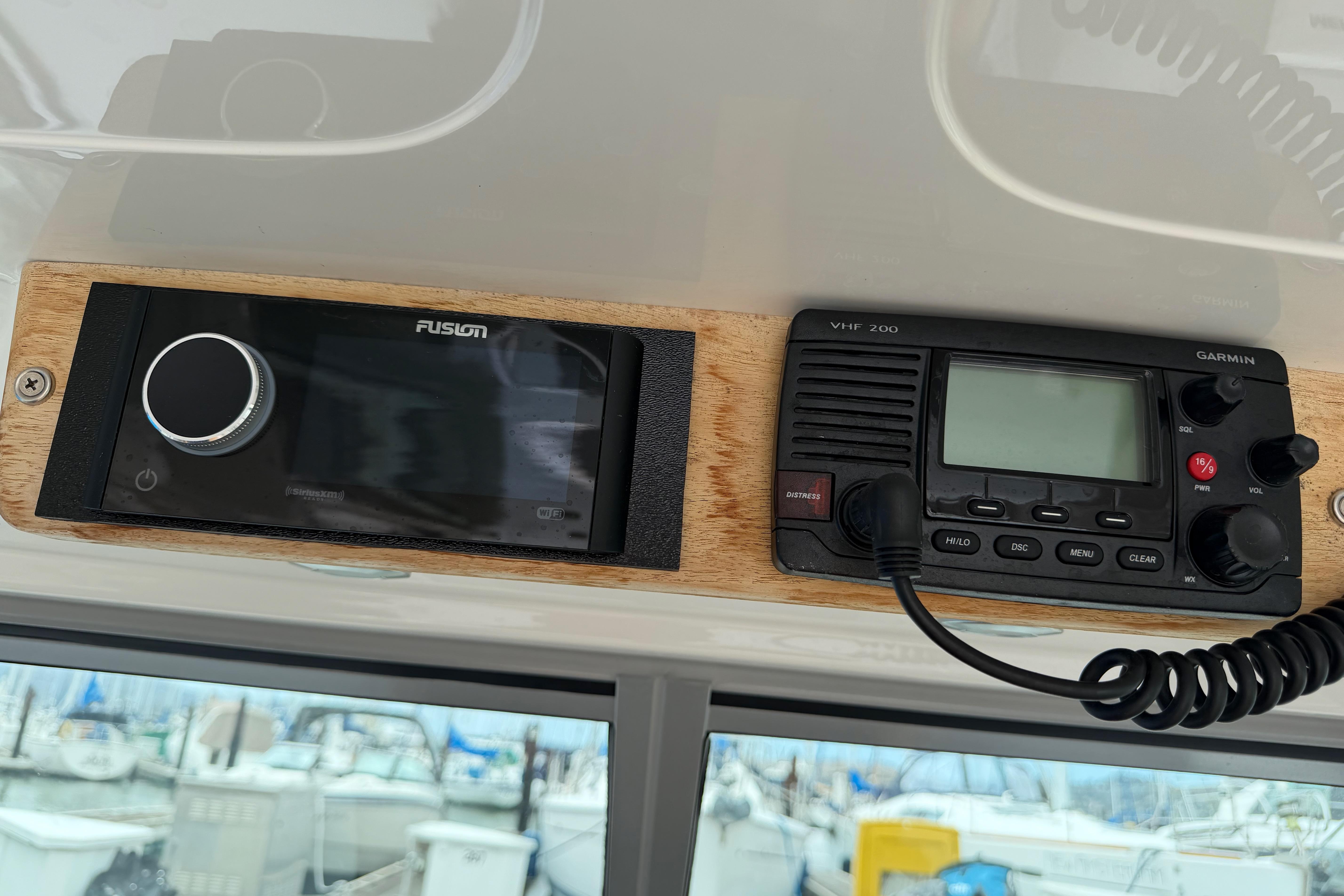 Fusion stereo and Garmin VHF 200 radio on 2016 Protector Targa 30 boat dashboard.