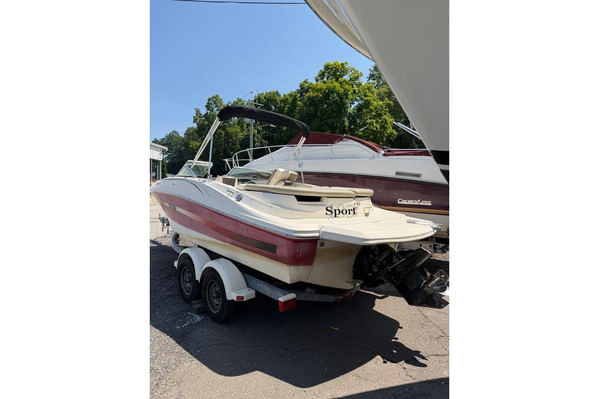 2006 Sea Ray 195 Sport boat on trailer, parked outdoors, with trees in the background.