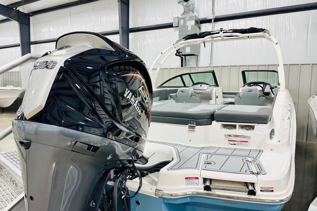 2025 Chaparral 23 SSi OB boat with Yamaha outboard motor in showroom.