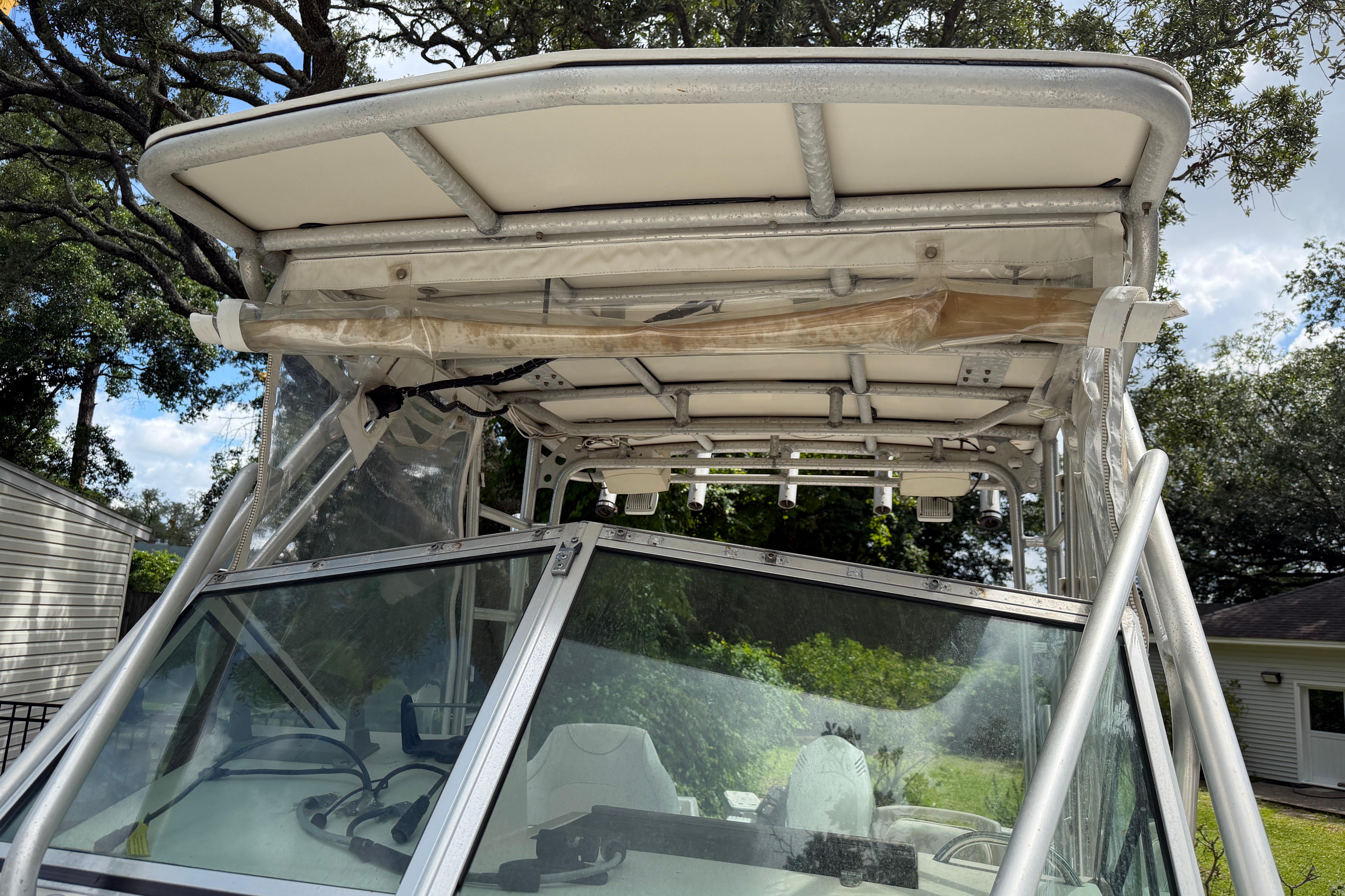 1987 Grady-White Seafarer 226 boat with T-top and windshield, parked outdoors.
